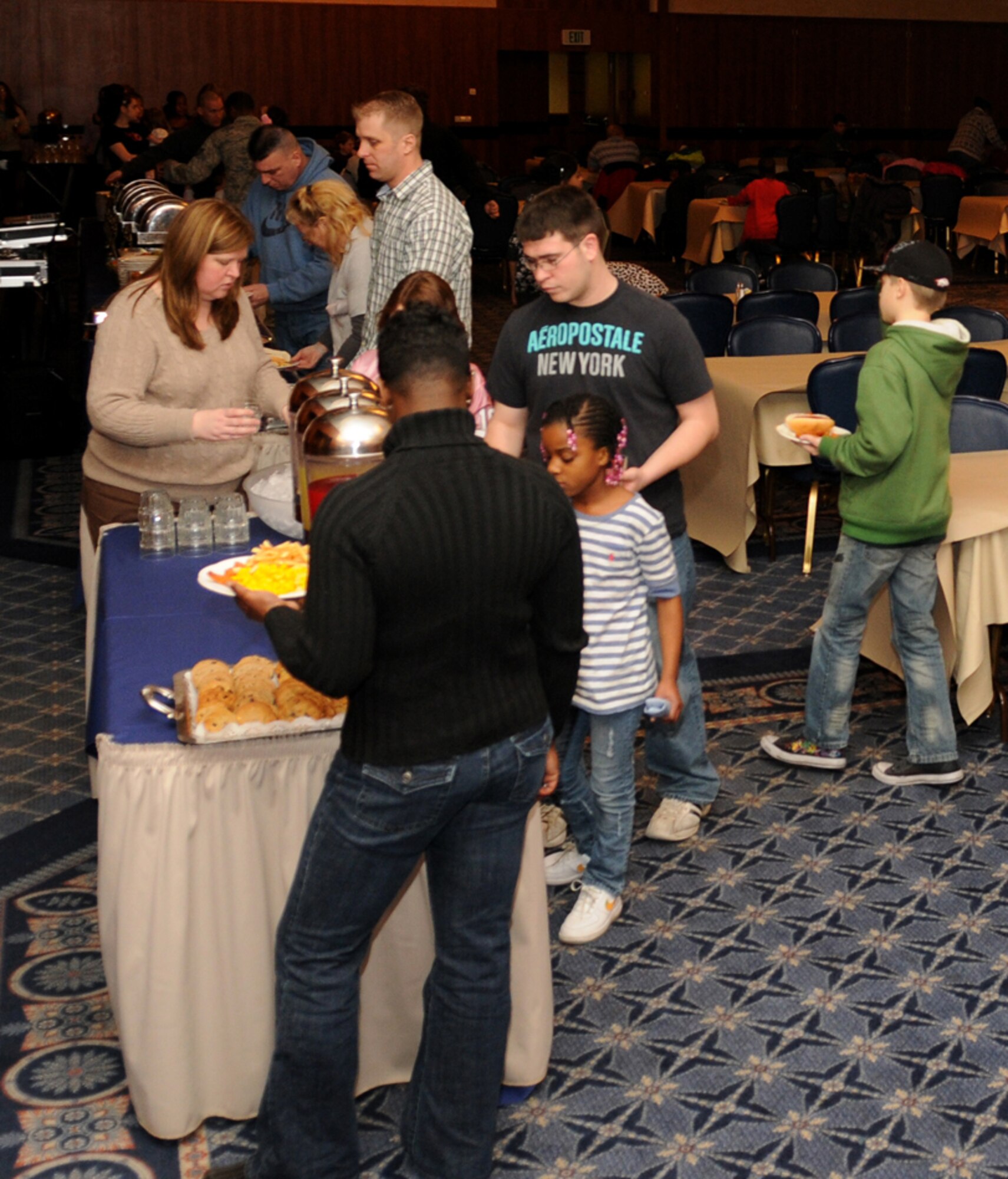 SPANGDAHLEM AIR BASE, Germany – Children and their parents line up for a food buffet during the Children’s Valentine’s Day party at Club Eifel Feb. 10. The party included food, movies, and arts and crafts for the children. (U.S. Air Force photo/Senior Airman Nathanael Callon)