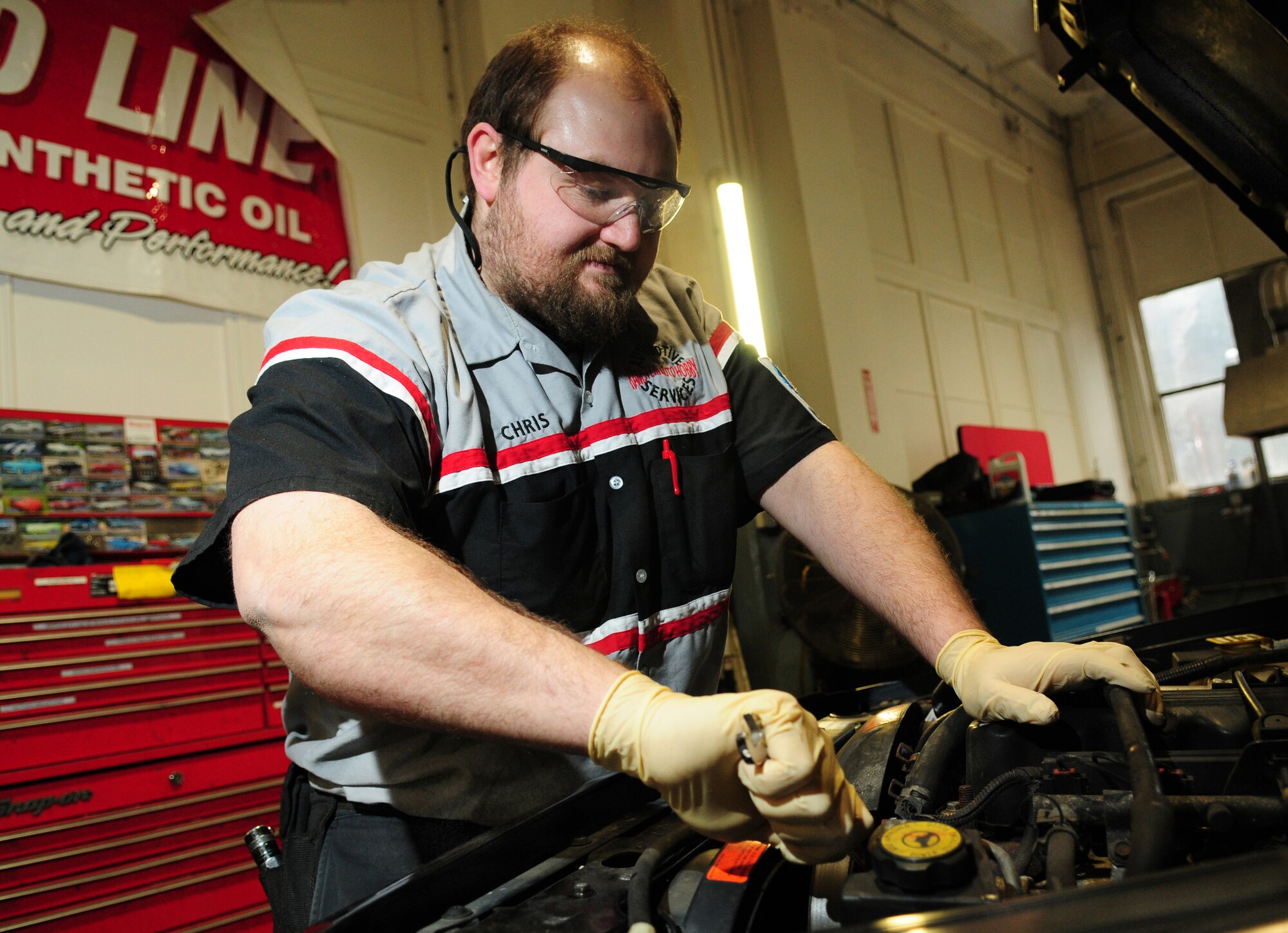 Christopher Gruenberg repairs an engine in the Ramstein Auto Repair Center garage on Ramstein Air Base, Germany, Feb.9, 2010. The repair center’s hours of operations are Monday through Friday, 0800 -  1700 and is located in building  2138.(U.S. Air Force photo by Airman Desiree Esposito)