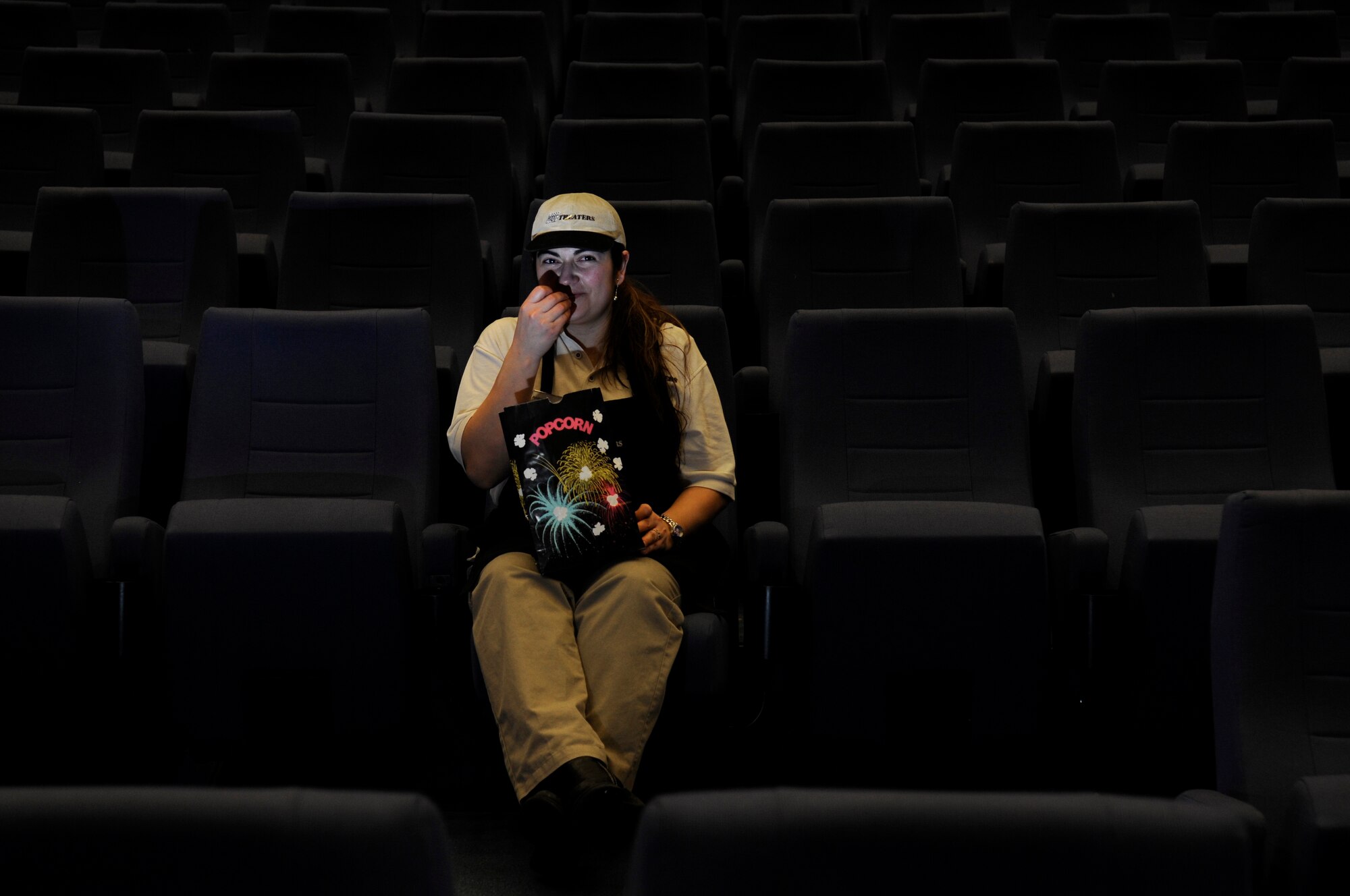 Andrea Aller, movie theater concessioner, poses for a photo at the KMCC Reel Time Theaters on Ramstein Air Base, Germany, Feb. 10, 2010. This four-plex theater, used by military members and families within the KMC, is the first of its kind in Army and Air Force Exchange Service Europe. (U.S. Air Force photo by Airman 1st Class Brittany Perry)
