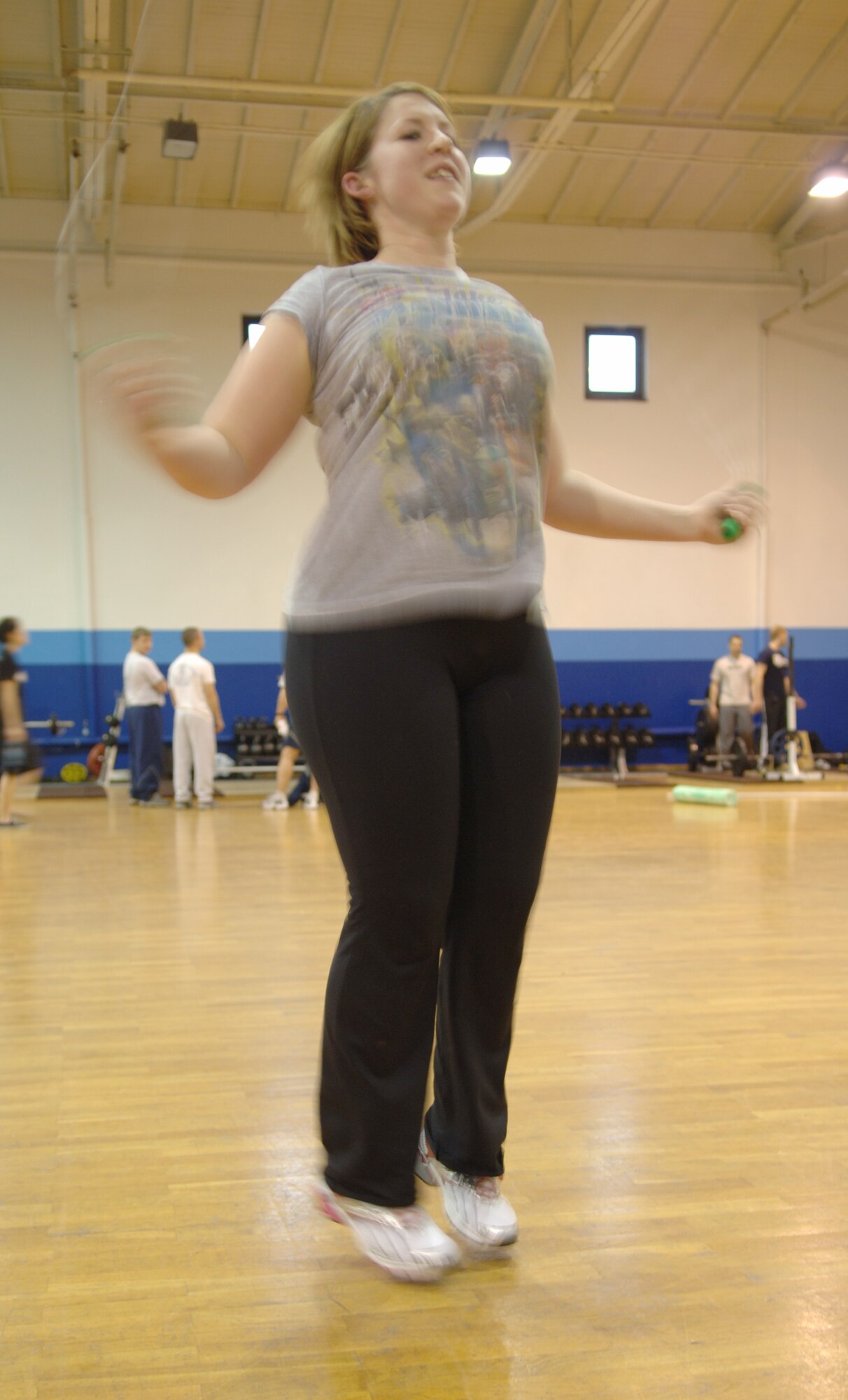 Jessica Andreasen, Air Force spouse, completes 300 sets with the jump rope during a work-out session with her personal trainer at the Northside Fitness Center, Ramstein Air Base, Germany, Feb. 10, 2010. Mrs. Andreasen is competing in the fourth-annual Biggest Loser Competition. (U.S. Air Force photo by Senior Airman Amanda Dick)