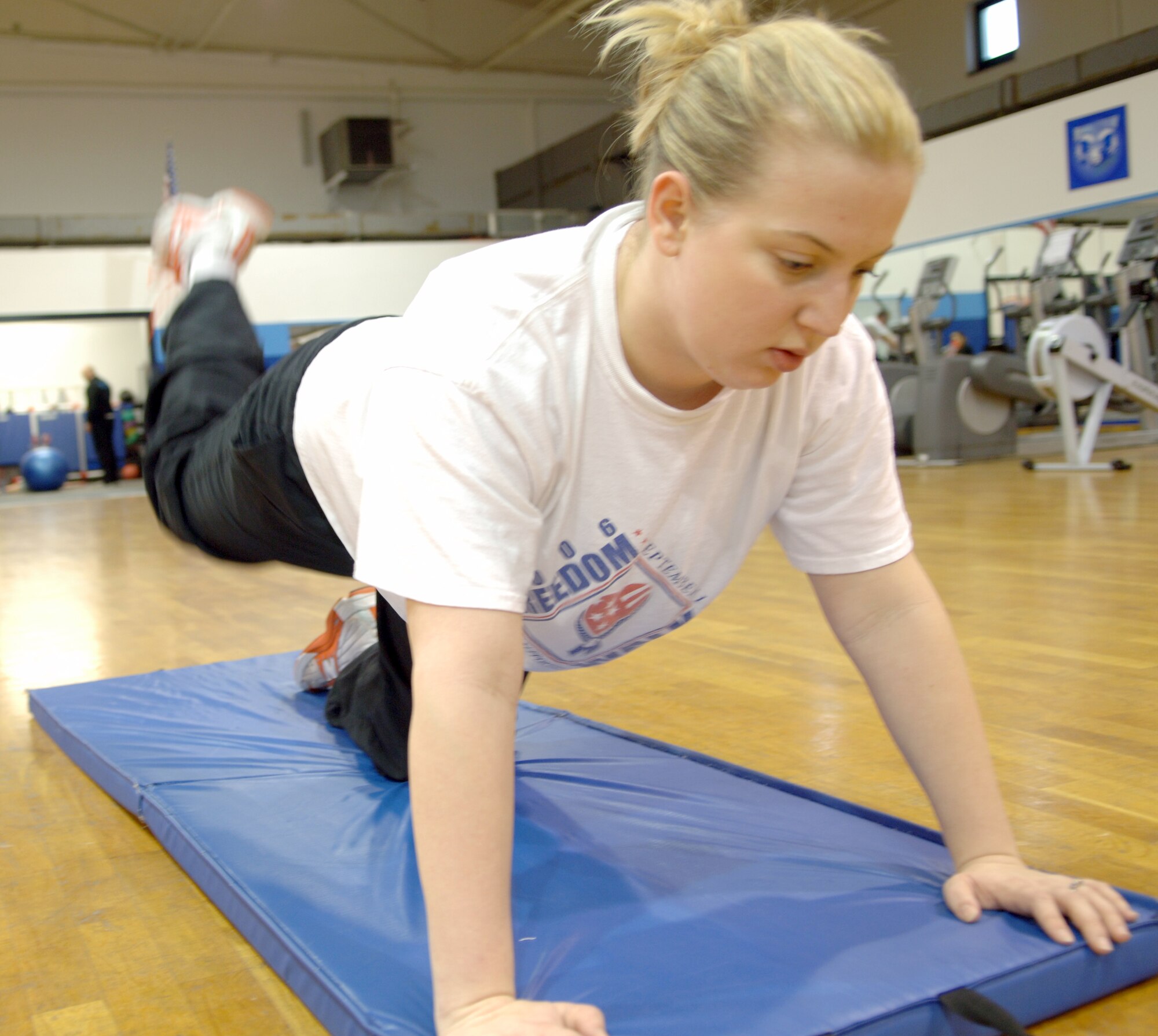 Naomi Voss, Air Force spouse, completes 40 sets of leg lifts during a work-out session with her personal trainer at the Northside Fitness Center, Ramstein Air Base, Germany, Feb. 10, 2010. Mrs. Voss is competing in the fourth-annual Biggest Loser Competition. (U.S. Air Force photo by Senior Airman Amanda Dick)