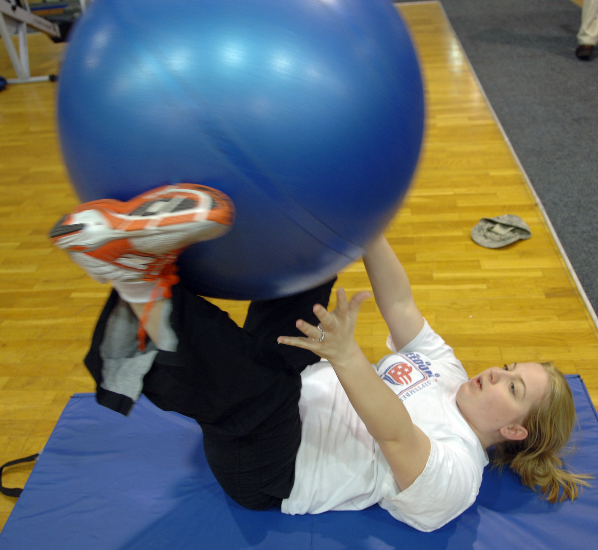 Naomi Voss, Air Force spouse, completes sets with a fitness ball during a work-out session with her personal trainer at the Northside Fitness Center, Ramstein Air Base, Germany, Feb. 10, 2010. Mrs. Voss is competing in the fourth-annual Biggest Loser Competition. (U.S. Air Force photo by Senior Airman Amanda Dick)