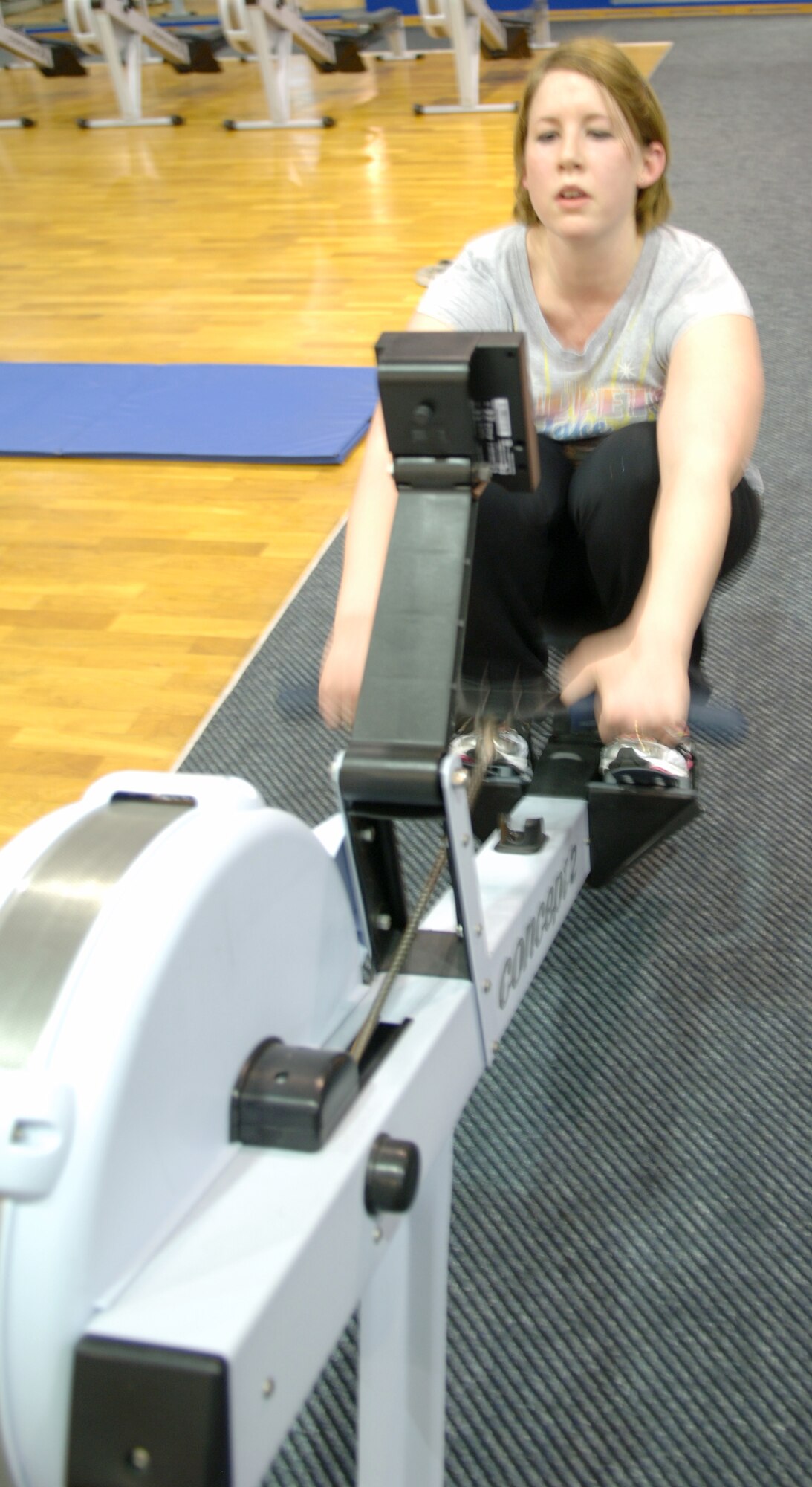 Jessica Andreasen, Air Force spouse, completes sets on the rower machine during a work-out session with her personal trainer at the Northside Fitness Center, Ramstein Air Base, Germany, Feb. 10, 2010. Mrs. Andreasen is competing in the fourth-annual Biggest Loser Competition. (U.S. Air Force photo by Senior Airman Amanda Dick)