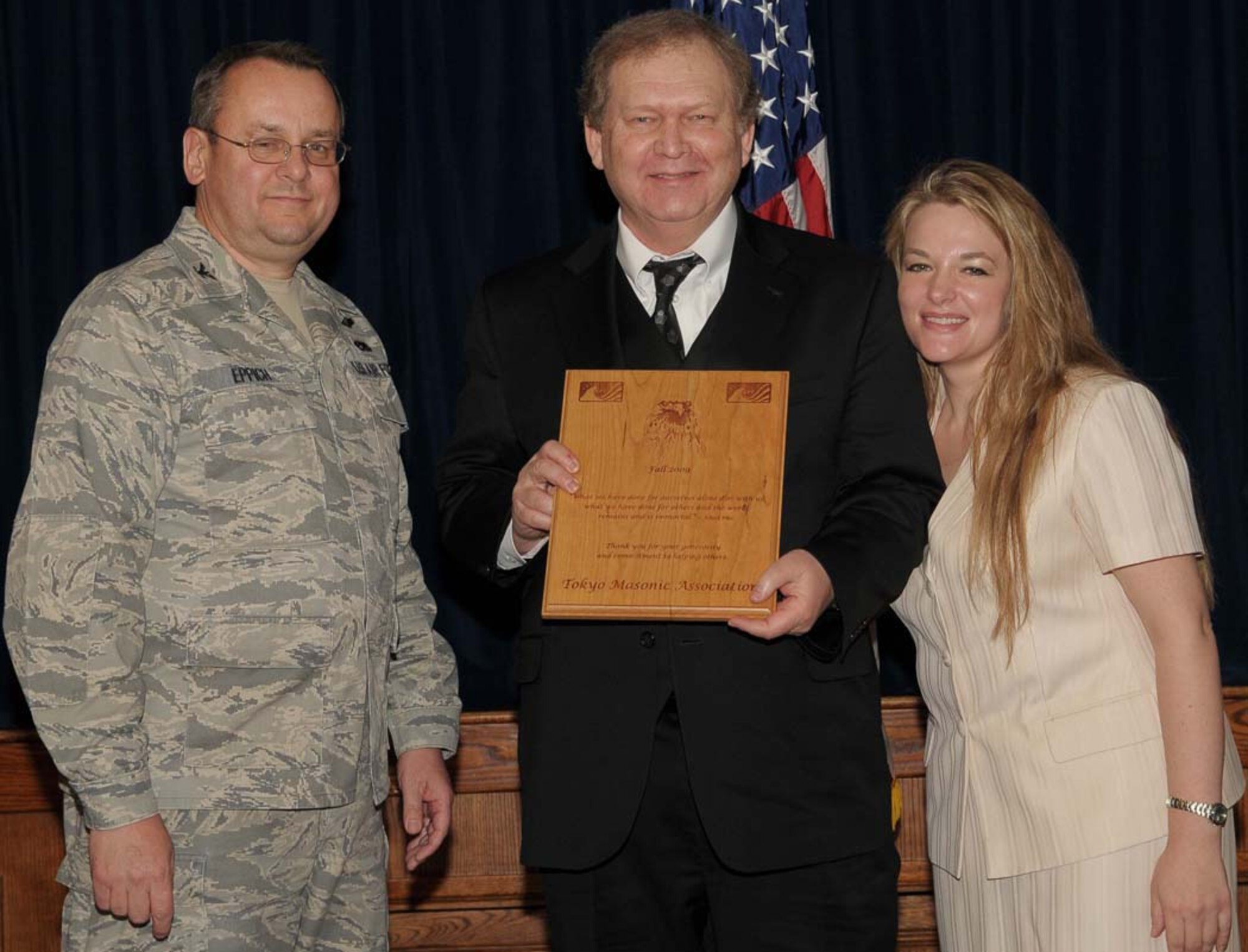 YOKOTA AIR BASE, Japan -- Col. Frank Eppich, 374th Airlift Wing vice commander, and Kitty Malcolm, CFC-O Pacific campaign coordinator, presents an appreciation award  to the Tokyo Masonic Association for their contribution to the CFC . The Combined Federal Campaign gives military members and civilian employees the chance to donate money to more than 2,000 charitable organizations. (U.S. Air Force photo/Airmen 1st Class Devin Doskey)