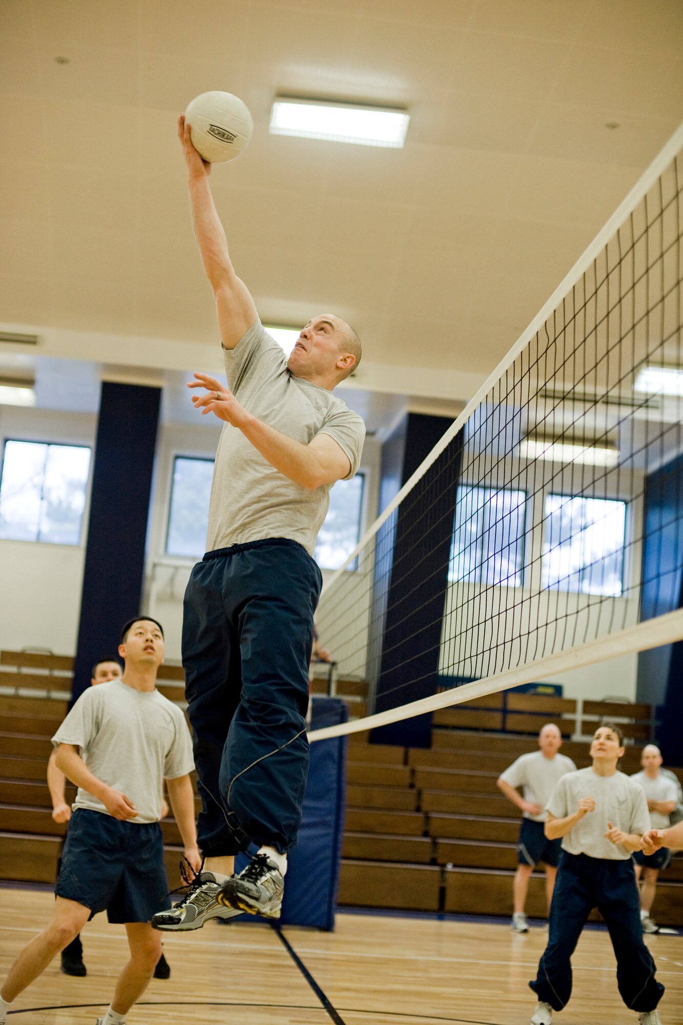 MISAWA AIR BASE, Japan -- Senior Airman Ryan Connolly, 35th Communications Squadron quality assurance evaluator, leaps to return a ball during a volleyball game between Airman Leadership School class 10-B and base leadership Feb. 10 at the Potter Fitness Center. The volleyball game served as an opportunity for the Airmen to bond with first sergeants, chiefs and commanders on base. The ALS class won two of the three games played. (U.S. Air Force photo/Senior Airman Jamal D. Sutter)
