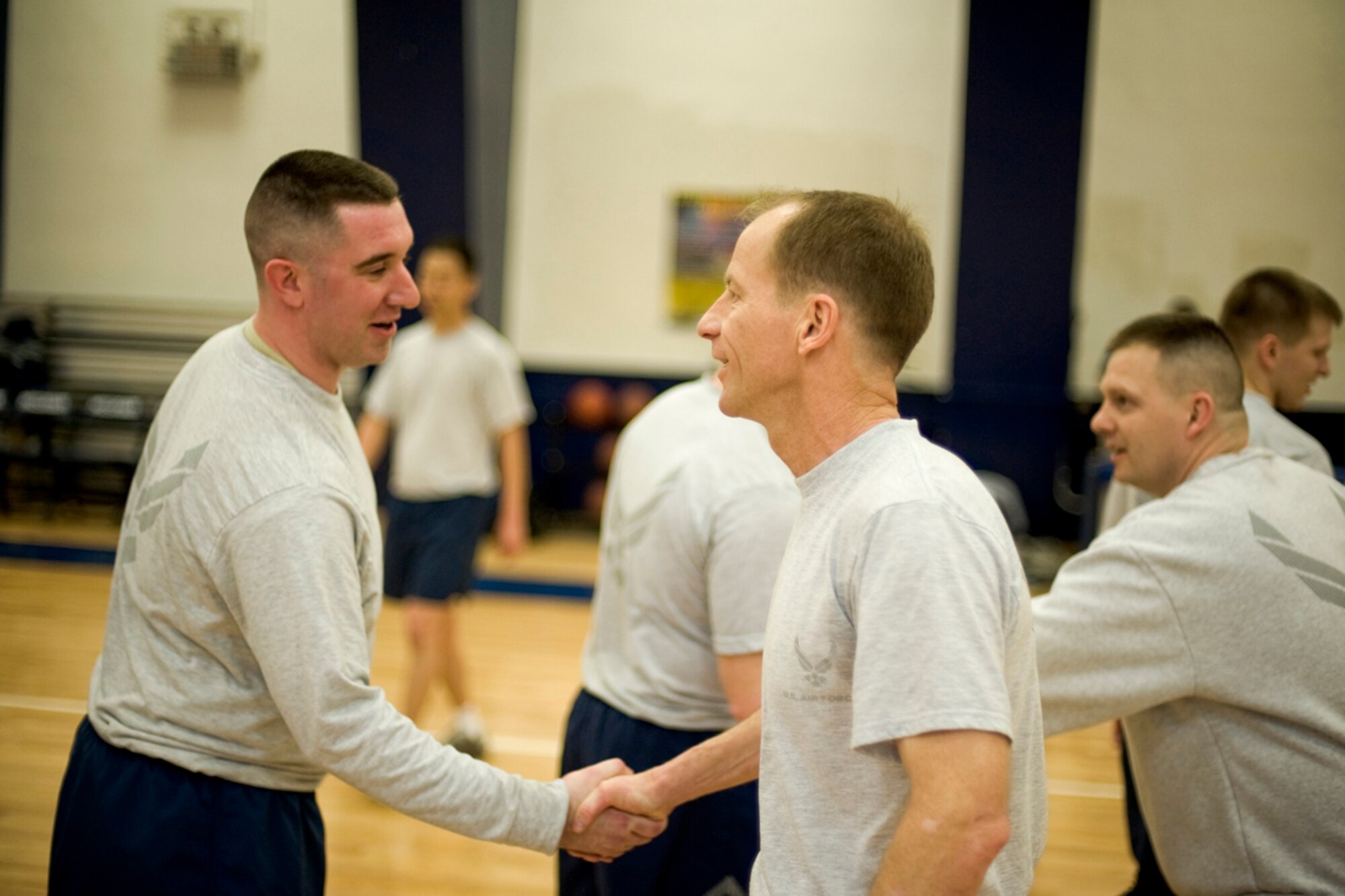 MISAWA AIR BASE, Japan -- Senior Airman Justin O'Grady, Airman Leadership School class 10-B class commander, shakes hands with Col. David Stilwell, 35th Fighter Wing commander, after a volleyball game Feb. 10 at the Potter Fitness Center. The ALS class won two of the three games played. (U.S. Air Force photo/Senior Airman Jamal D. Sutter)