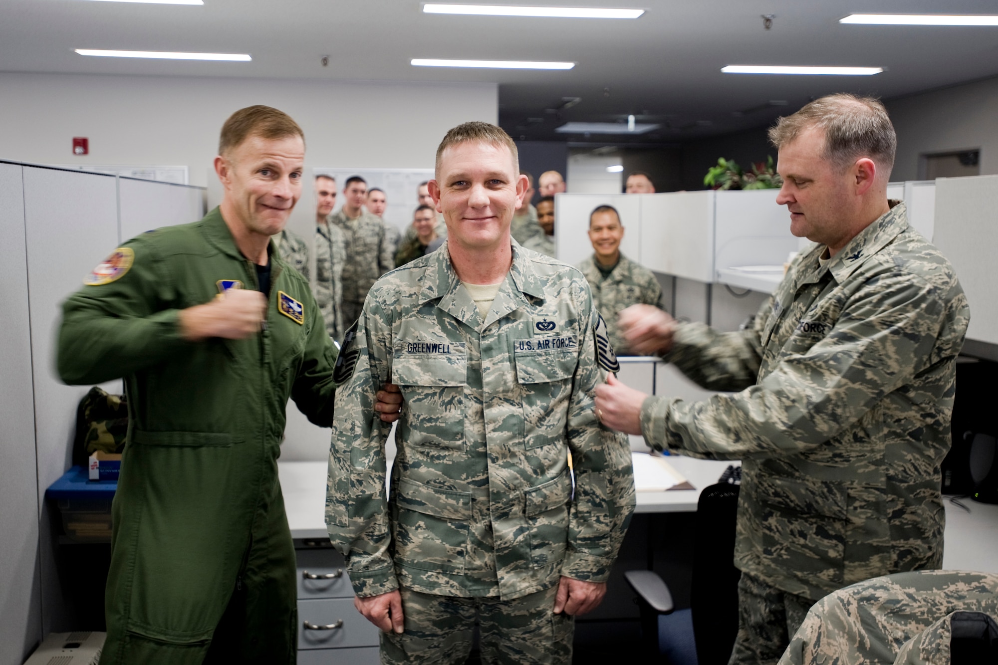 MISAWA AIR BASE, Japan -- Col. RC Craig, 35th Fighter Wing vice commander, and Col. Jeffrey Lanning, 35th Mission Support Group deputy commander, tack on master sergeant stripes to Tech. Sgt. Lee Greenwell, 35th Civil Engineer Squadron war reserve material manager, Feb. 12 at the 35th CES compound. Sergeant Greenwell was STEP promoted after his promotion package won at the 5th Air Force and Pacific Air Force levels. Sergeant Greenwell is a Deepwater, Mo., native. (U.S. Air Force photo/Senior Airman Jamal D. Sutter)