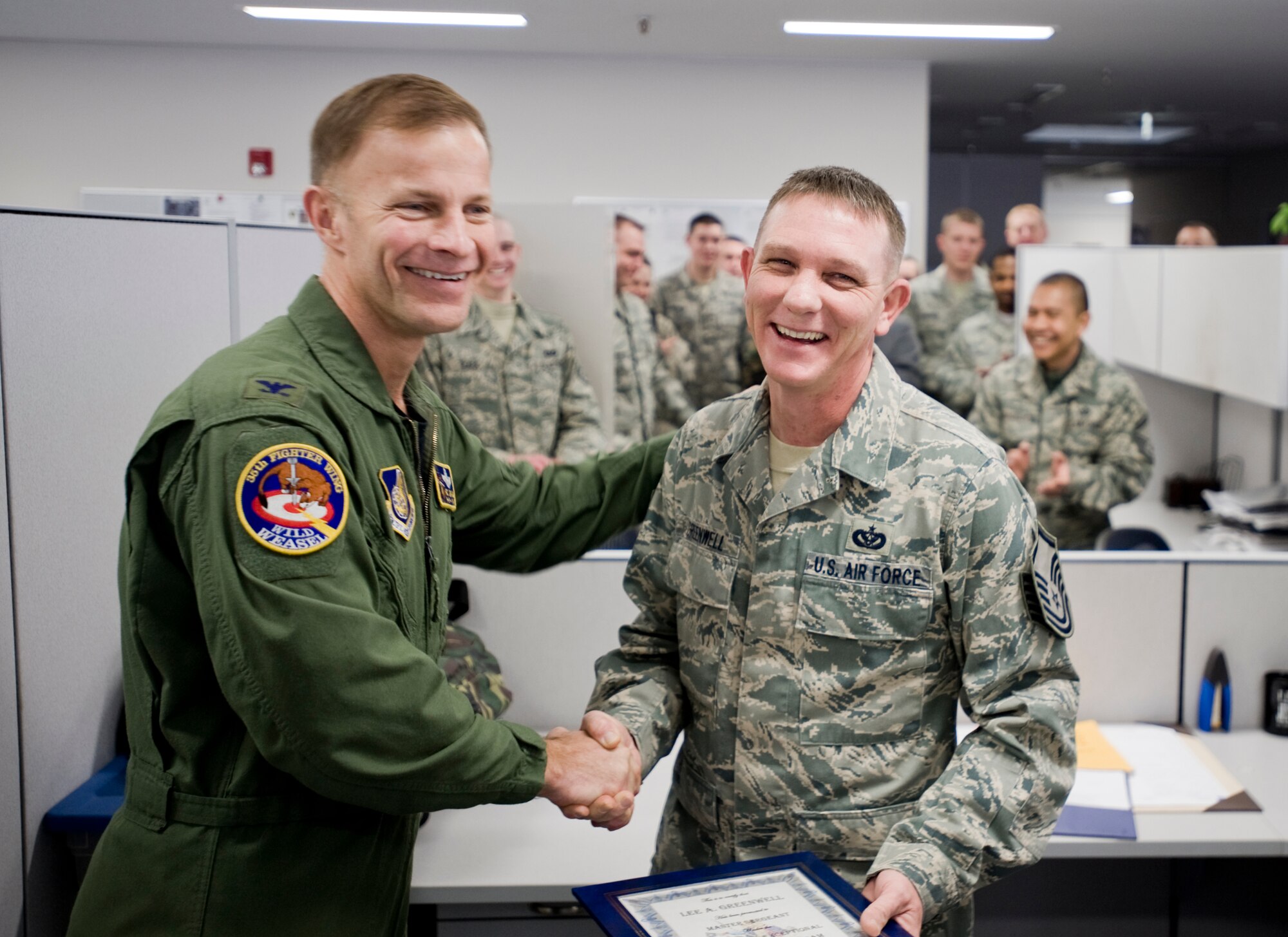 MISAWA AIR BASE, Japan -- Newly-promoted Master Sgt. Lee Greenwell, 35th Civil Engineer Squadron war reserve material manager, and Col. RC Craig, 35th Fighter Wing vice commander, share laughs Feb. 12 at the 35th CES compound. Friends and members of Sergeant Greenwell's unit gathered as Colonel Craig presented him his promotion. (U.S. Air Force photo/Senior Airman Jamal D. Sutter)