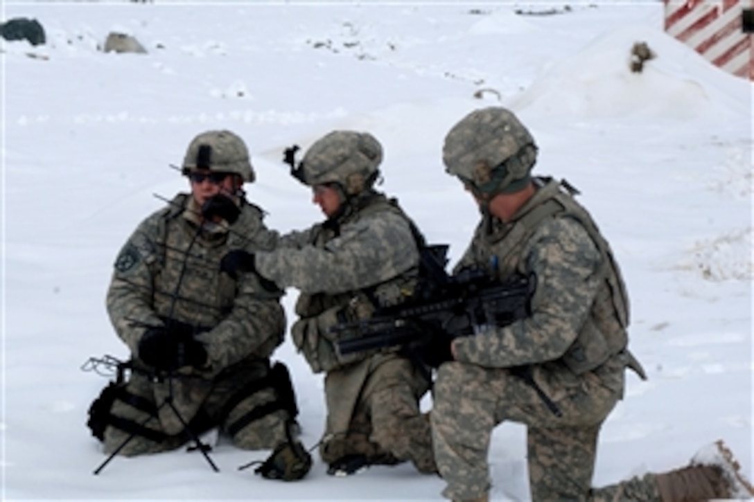 U.S. Army soldiers set up a satellite antenna for communications so they can deliver humanitarian assistance to Afghans in the Salang district of Afghanistan, Feb. 10, 2010. The soldiers are assigned to the 410th Military Police Company from Fort Hood, Texas.