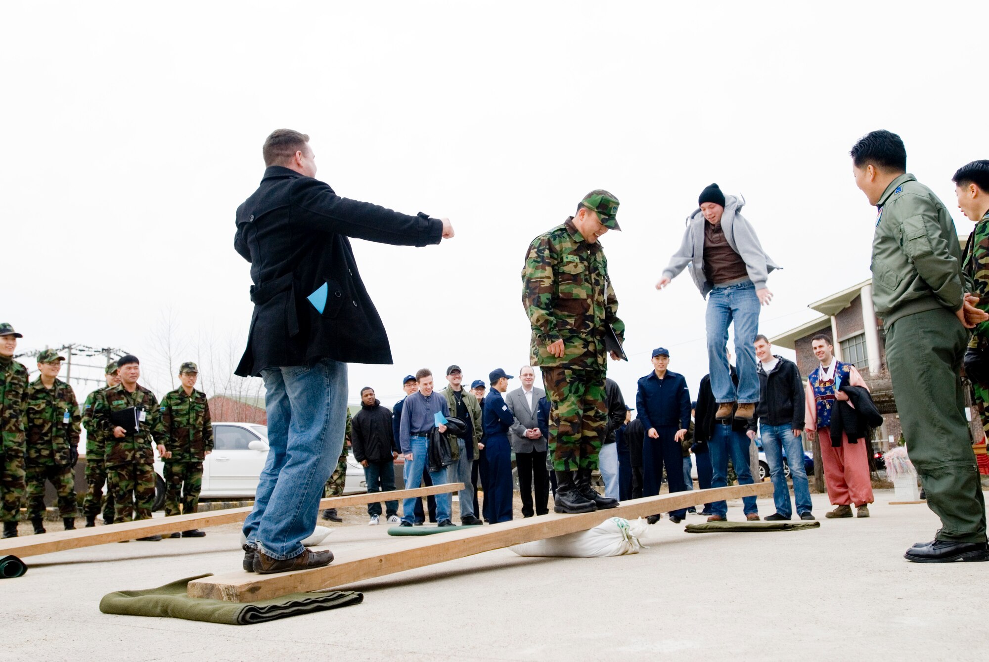 KUNSAN AIR BASE, Republic of Korea -- U.S. Air Force Staff Sgt Matthew McClarin,8th Maintenance Squadron, launches Senior Airman Joshua Wood, 8th Security Forces Squadrib, while playing Nol-Ttwigi, a traditional Korean game, at the New Years Day Joint Ceremony Feb. 14. The New Years Day Joint Ceremony brought together Korean and United States Airmen to celebrate the Korean New Year. The ceremony consisted of ancestor memorial services, New Year's bow and traditional Korean food and games. (U.S. Air Force photo/Senior Airman Jonathan Steffen)