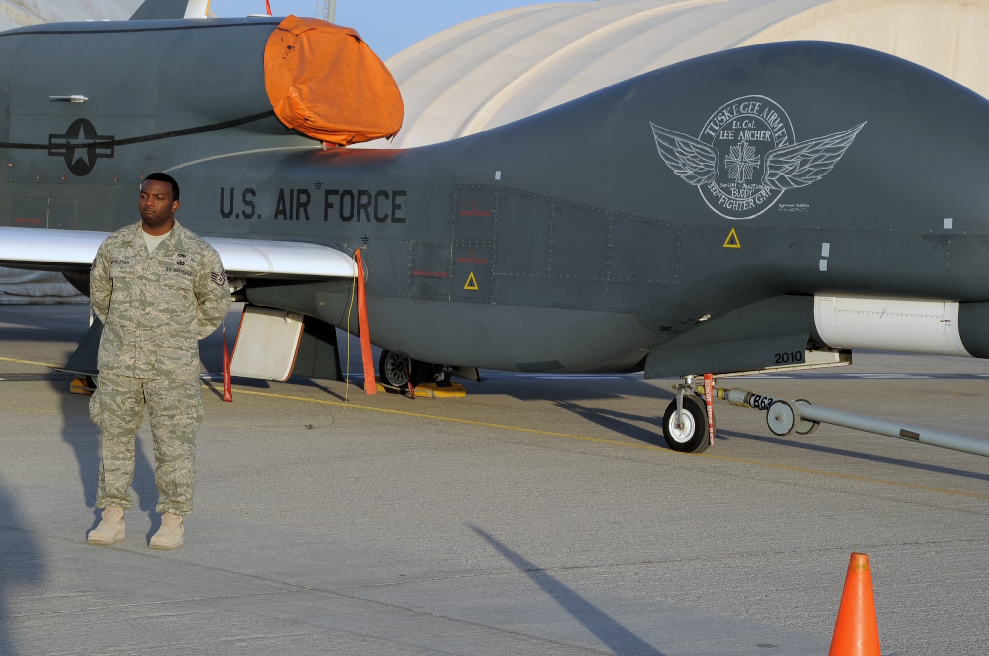 Staff Sgt. Michael Middleton of the 380th Expeditionary Aircraft Maintenance Squadron's Global Hawk aircraft maintenance unit, pictured here on Feb. 12, 2010, created the chalk nose art on an RQ-4 Global Hawk at a non-disclosed base in Southwest Asia honoring Tuskegee Airman Lt. Col. Lee Archer who died Jan. 27 at the age of 90 in New York City. (U.S. Air Force Photo/Master Sgt. Scott T. Sturkol/Released)
