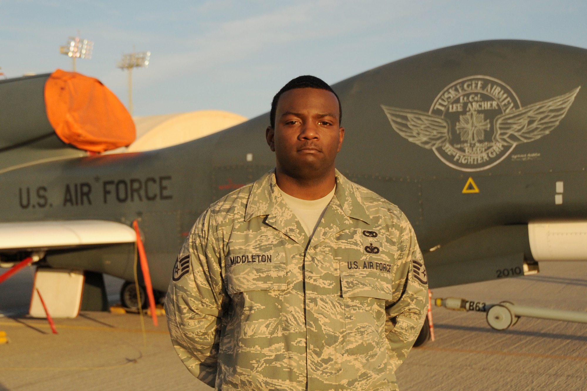 Staff Sgt. Michael Middleton of the 380th Expeditionary Aircraft Maintenance Squadron's Global Hawk aircraft maintenance unit, pictured here on Feb. 12, 2010, created the chalk nose art on an RQ-4 Global Hawk at a non-disclosed base in Southwest Asia honoring Tuskegee Airman Lt. Col. Lee Archer who died Jan. 27 at the age of 90 in New York City. (U.S. Air Force Photo/Senior Airman Jenifer Calhoun/Released)