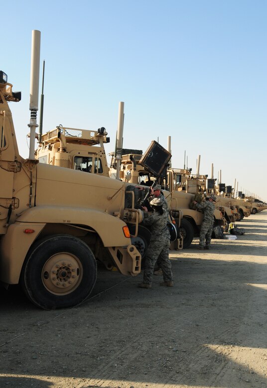 U.S. Air Force Airmen assigned to the 586th Expeditionary Logistics Readiness Squadron's 70th Medium Truck Detachment ready their vehicles for a mail mission to military installations within Southwest Asia Jan. 27, 2010. The unit took on the mail mission Dec. 28, 2009, when a Department of Defense contract with a transport company was halted. (U.S. Air Force photo by Staff Sgt. Lakisha A. Croley/Released)