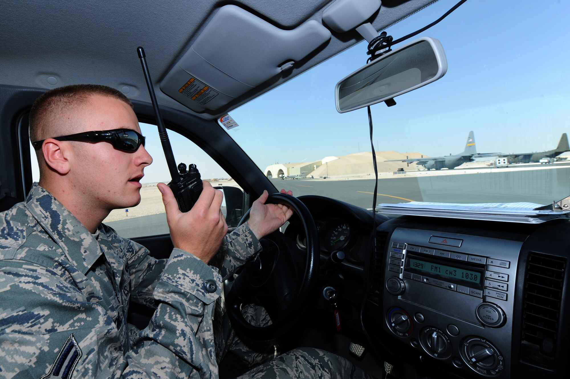 Airman 1st Class Christopher McComas, 379th Expeditionary Operations Support Squadron airfield operations coordinator, contacts a sweeper to clear foreign object debris on a flightline at a non-disclosed Southwest Asia location Feb. 7, 2010. (U.S. Air Force photo by Senior Airman Kasey Zickmund)[RELEASED]
