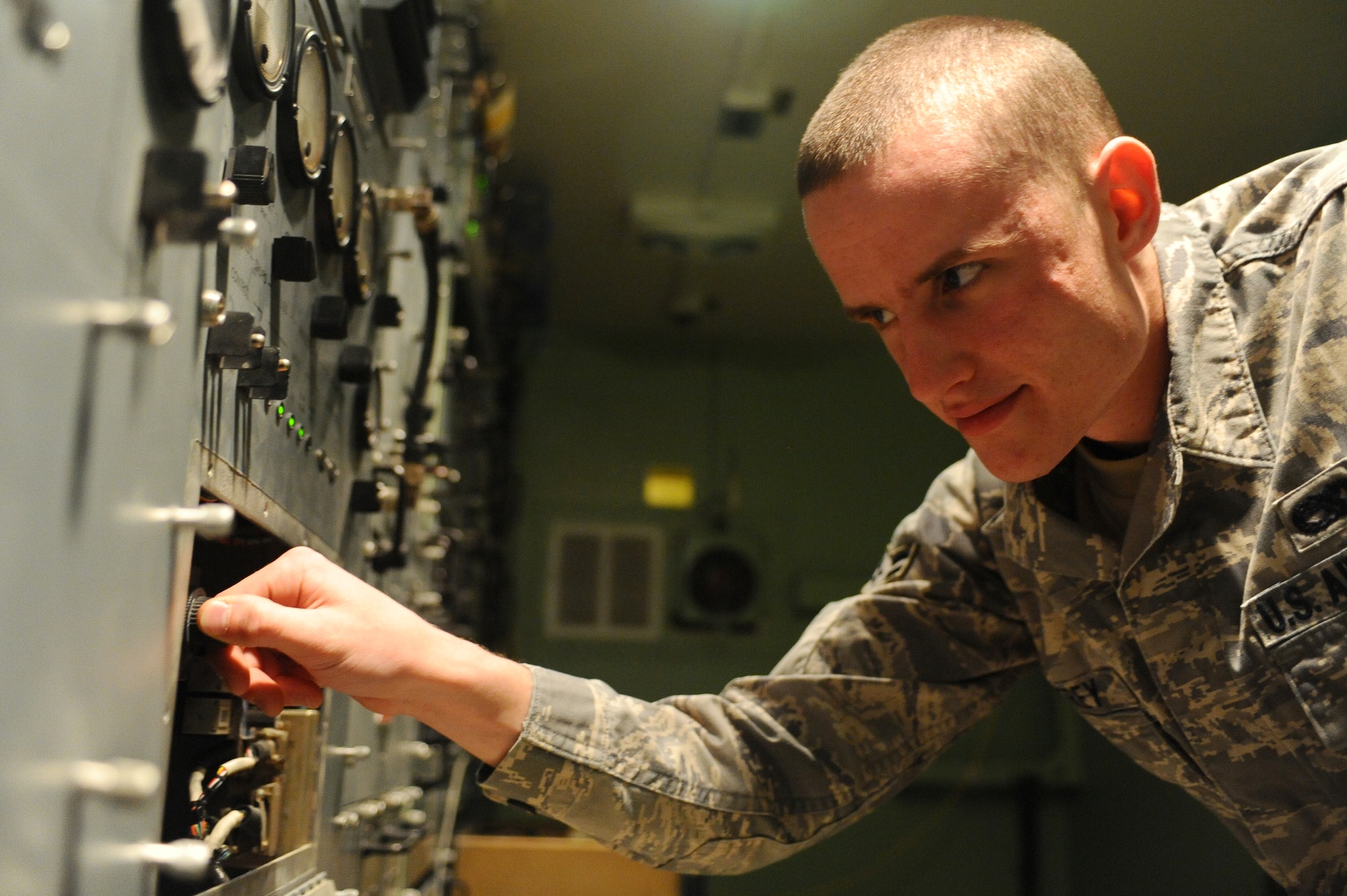 Airman 1st Class James Godfrey, 379th Expeditionary Communications Squadron satellite communications apprentice, adjusts the frequency of a high-power amplifier on a TRC-170 Troposheric Scatter Microwave Radio Terminal at a non-disclosed Southwest Asia location Jan. 30, 2010. (U.S. Air Force photo by Senior Airman Kasey Zickmund)[RELEASED]