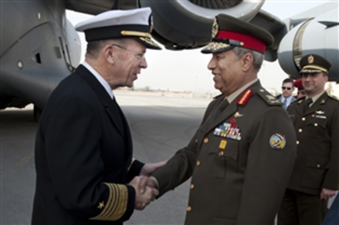 Egyptian Maj. Gen. Hassan Roweny, right, greets U.S. Navy Adm. Mike Mullen, chairman of the Joint Chiefs of Staff, upon his arrival in Cairo, Egypt, Feb. 13, 2010. Mullen is on a weeklong tour of the region visiting with key partners and allies.