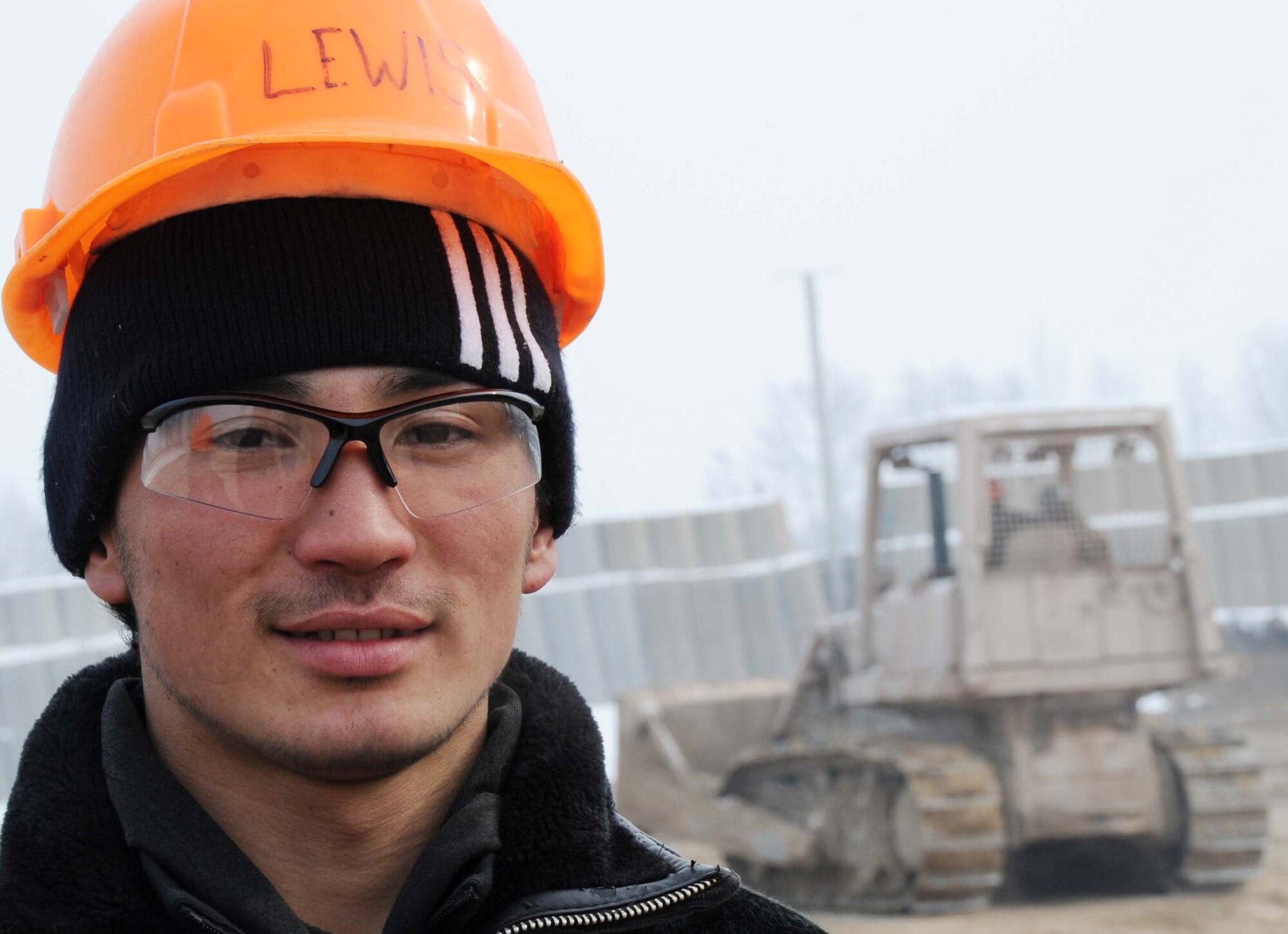 Marsud Abduraimoj, a Jeni Jehr Vocational School student, surveys the new construction area of the Transit Center at Manas, Kyrgyzstan, Feb. 13.  20 students visited the installation to see how 376th Expeditionary Civil Engineer Squadron Airmen conduct military operations here and learn different civil engineer techniques. (U.S. Air Force photo/Senior Airman Nichelle Anderson/released)