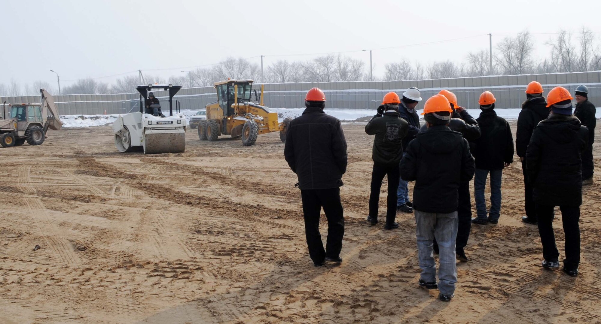 Students from the Jeni Jehr Vocational School, Kyrgyzstan, see the new construction area of the Transit Center at Manas Feb. 13.  20 students visited the 376th Expeditionary Civil Engineer Squadron to see how Airmen conduct military operations here and learn different civil engineer techniques. (U.S. Air Force photo/Senior Airman Nichelle Anderson/released)