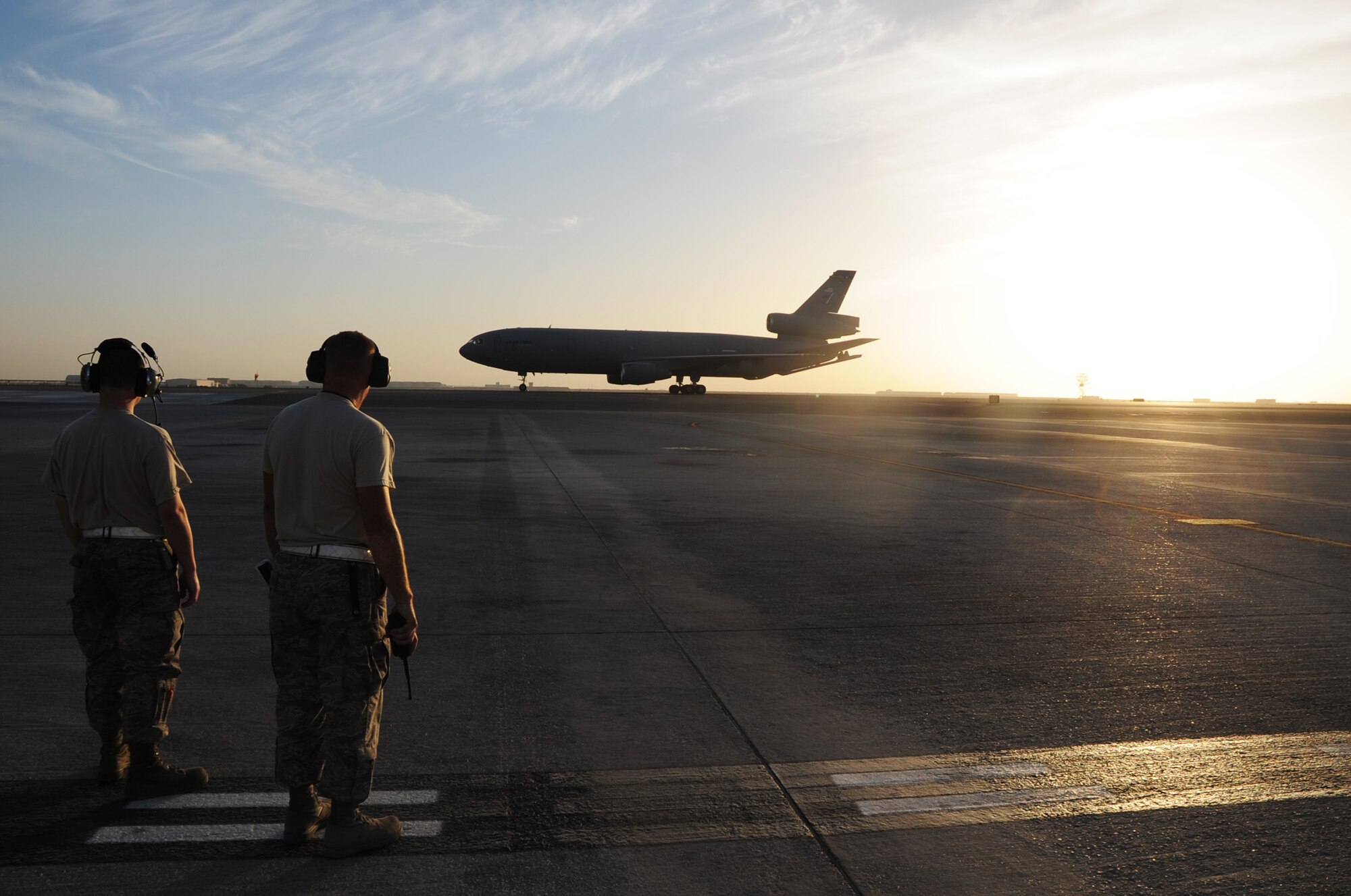 Maintenance Airmen wait as a KC-10 Extender returns from a mission during flightline operations for the 380th Air Expeditionary Wing at a non-disclosed location in Southwest Asia on Feb. 12, 2010.  The KC-10 is forward deployed to the U.S. Central Command area of responsibility from Joint Base McGuire-Dix-Lakehurst, N.J. (U.S. Air Force Photo/Master Sgt. Scott T. Sturkol/Released)