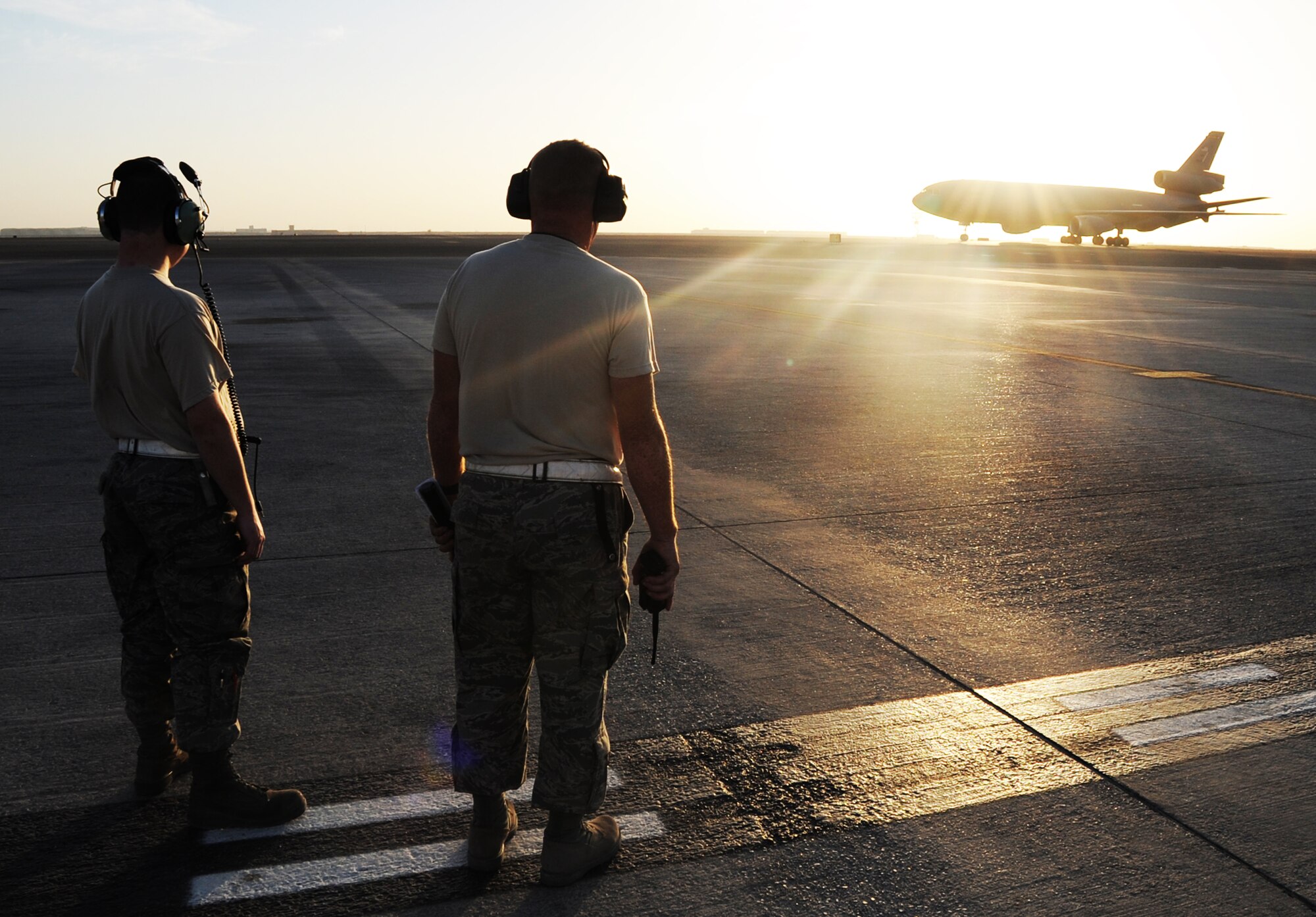 Maintenance Airmen wait as a KC-10 Extender returns from a mission during flightline operations for the 380th Air Expeditionary Wing at a non-disclosed location in Southwest Asia on Feb. 12, 2010.  The KC-10 is forward deployed to the U.S. Central Command area of responsibility from Joint Base McGuire-Dix-Lakehurst, N.J. (U.S. Air Force Photo/Master Sgt. Scott T. Sturkol/Released)