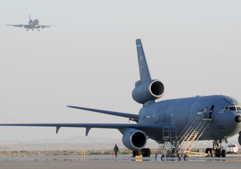 Maintenance Airmen prepare a KC-10 Extender for a mission while another KC-10 returns from a mission during flightline operations for the 380th Air Expeditionary Wing at a non-disclosed location in Southwest Asia on Feb. 12, 2010.  The KC-10 is forward deployed to the U.S. Central Command area of responsibility from Travis Air Force Base, Calif. (U.S. Air Force Photo/Master Sgt. Scott T. Sturkol/Released)