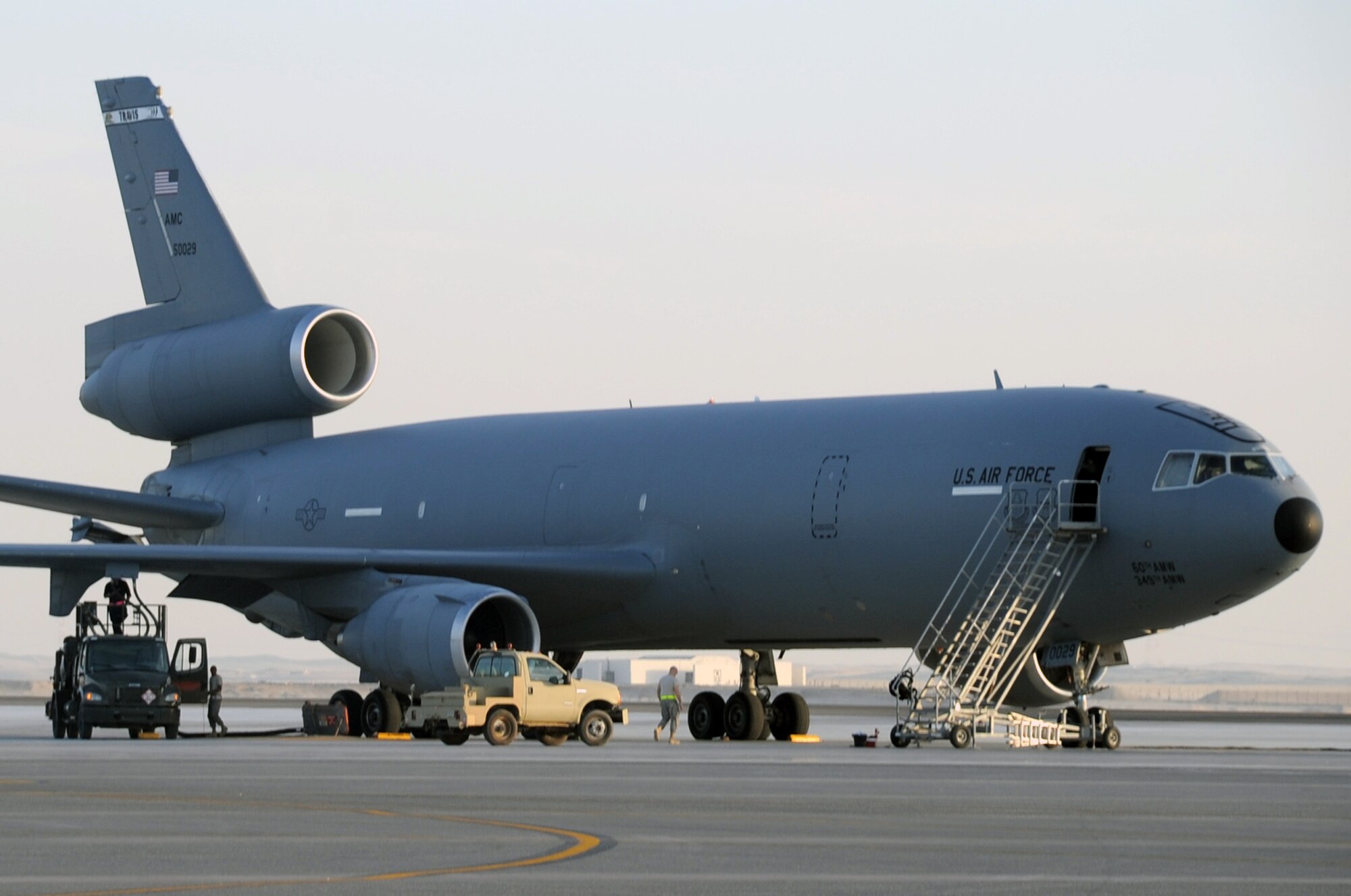 Maintenance and fuel Airmen prepare a KC-10 Extender for a mission during flightline operations for the 380th Air Expeditionary Wing at a non-disclosed location in Southwest Asia on Feb. 12, 2010.  The KC-10 is forward deployed to the U.S. Central Command area of responsibility from Travis Air Force Base, Calif. (U.S. Air Force Photo/Master Sgt. Scott T. Sturkol/Released)