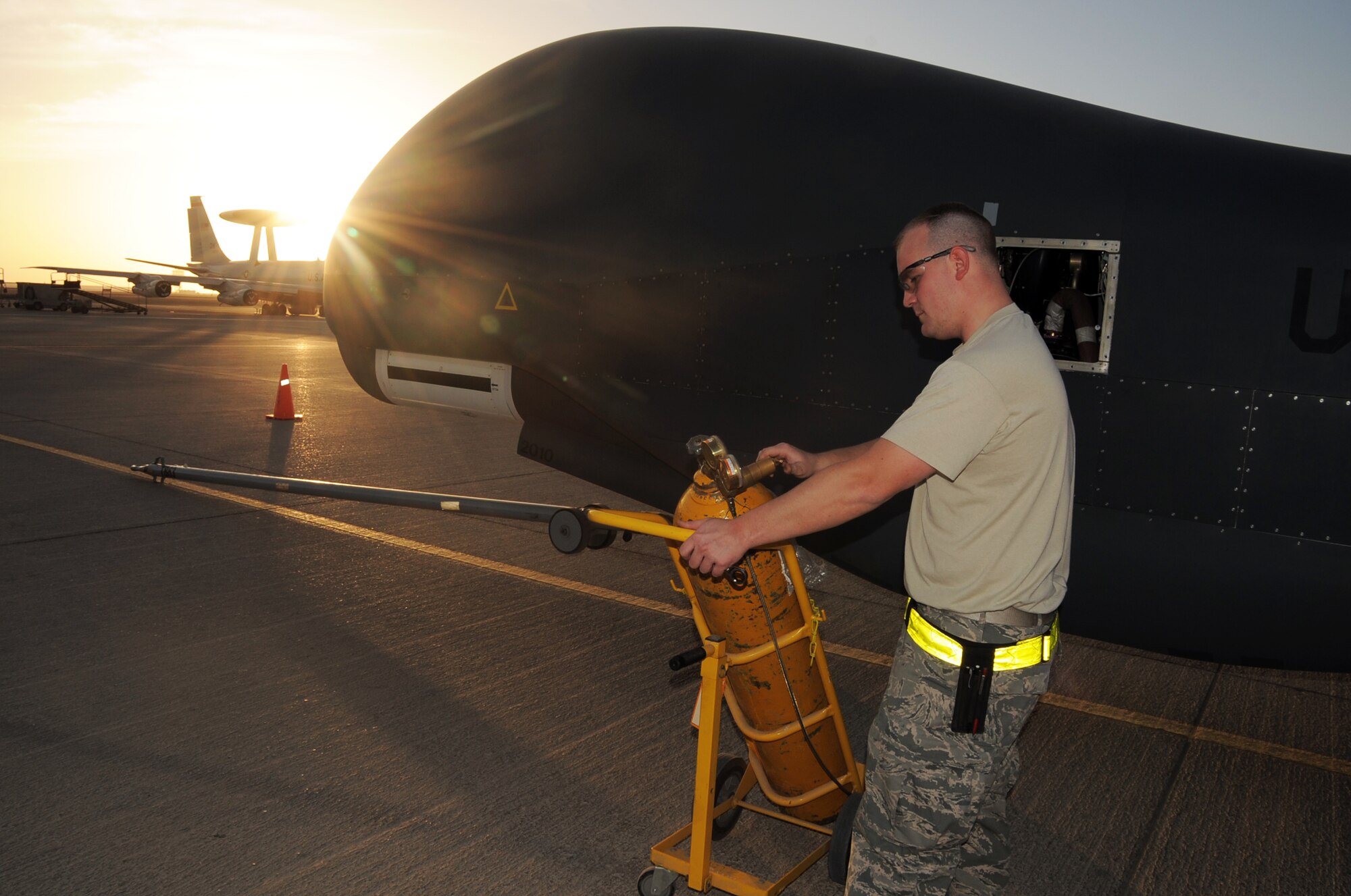 Staff Sgt. Michael Goenner, an RQ-4 Global Hawk crew chief with the 380th Expeditionary Aircraft Maintenance Squadron Hawk aircraft maintenance unit, goes through pre-flight servicing while preparing a Global Hawk for a combat mission Feb. 12, 2010, at a non-disclosed base in Southwest Asia. The RQ-4s, assigned to the 380th Air Expeditionary Wing and deployed from Beale Air Force Base, Calif., achieved 1,500 combat sorties and 30,000 combat flying hours on Feb. 10 and 11 respectively.  Sergeant Goenner is deployed from the 9th Aircraft Maintenance Squadron at Beale AFB, and his hometown is Becker, Minn. (U.S. Air Force Photo/Master Sgt. Scott T. Sturkol/Released)
