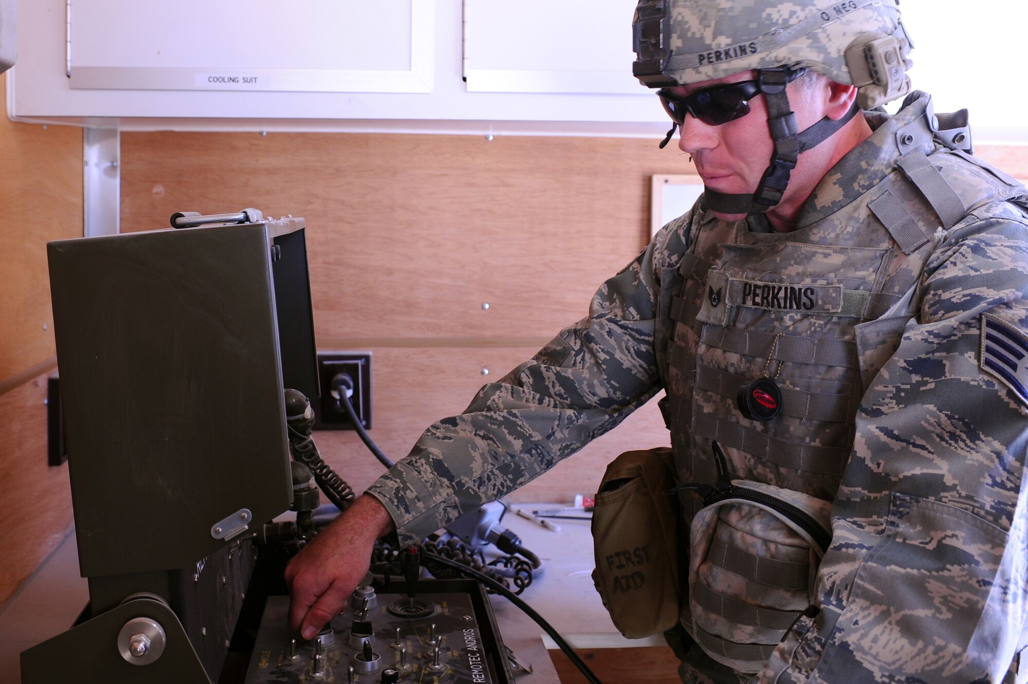 Staff Sgt. Michael Perkins, 379th Expeditionary Civil Engineer Squadron explosive ordnance disposal technician, controls an ANDROS F6 Robot to assess an exercise scenario before emergency personnel take action at a non-disclosed Southwest Asia location Feb. 12, 2010. (U.S. Air Force photo by Senior Airman Kasey Zickmund)[RELEASED]
