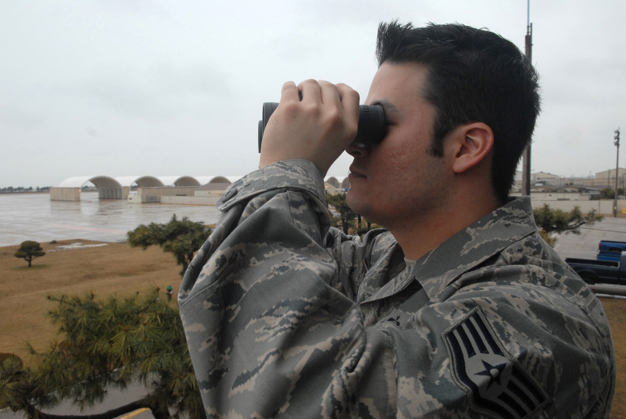 KUNSAN AIR BASE, Republic of Korea -- Staff Sgt. Jack Cotham, 8th Operation Support Squadron weather forecaster, observes weather conditions on the flightline Feb. 11. Air Force weather technicians deliver the highest quality tailored weather and space environment information, products and services. (U.S. Air Force photo/Senior Airman Roy Lynch)