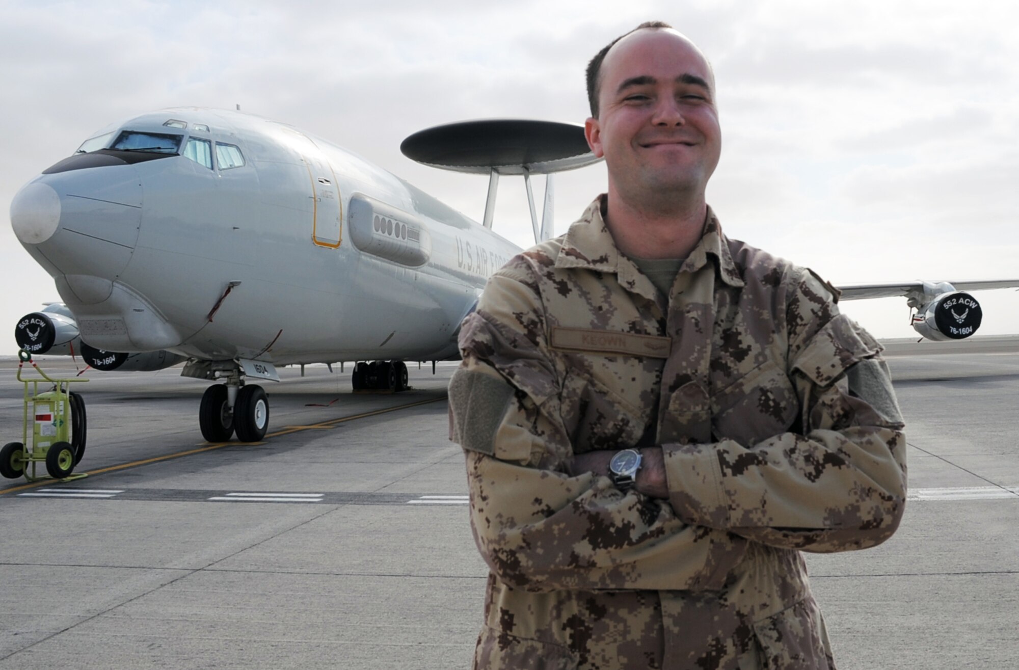 Canadian Forces Master Cpl. Mark Keown is an air surveillance technician serving with the 965th Expeditionary Airborne Air Control Squadron at a non-disclosed base in Southwest Asia. Here he is pictured next to an E-3 Sentry Airborne Warning and Control System aircraft on Jan. 28, 2010.  He is one of five Canadian Forces members deployed with the squadron.  Master Corporal Keown's hometown is Powassan, Ontario, Canada.  (U.S. Air Force Photo/Master Sgt. Scott T. Sturkol/Released)