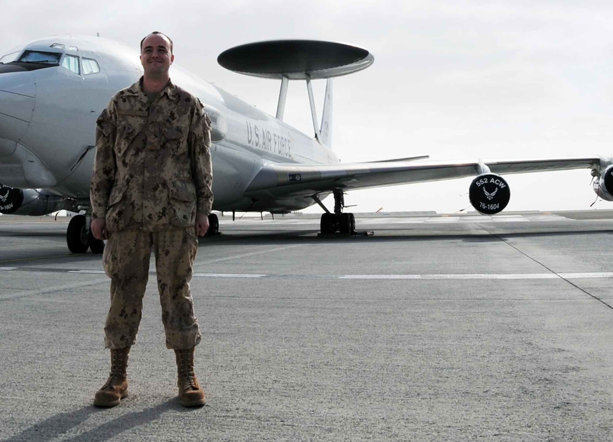 Canadian Forces Master Cpl. Mark Keown is an air surveillance technician serving with the 965th Expeditionary Airborne Air Control Squadron at a non-disclosed base in Southwest Asia. Here he is pictured next to an E-3 Sentry Airborne Warning and Control System aircraft on Jan. 28, 2010.  He is one of five Canadian Forces members deployed with the squadron.  Master Corporal Keown's hometown is Powassan, Ontario, Canada.  (U.S. Air Force Photo/Master Sgt. Scott T. Sturkol/Released)