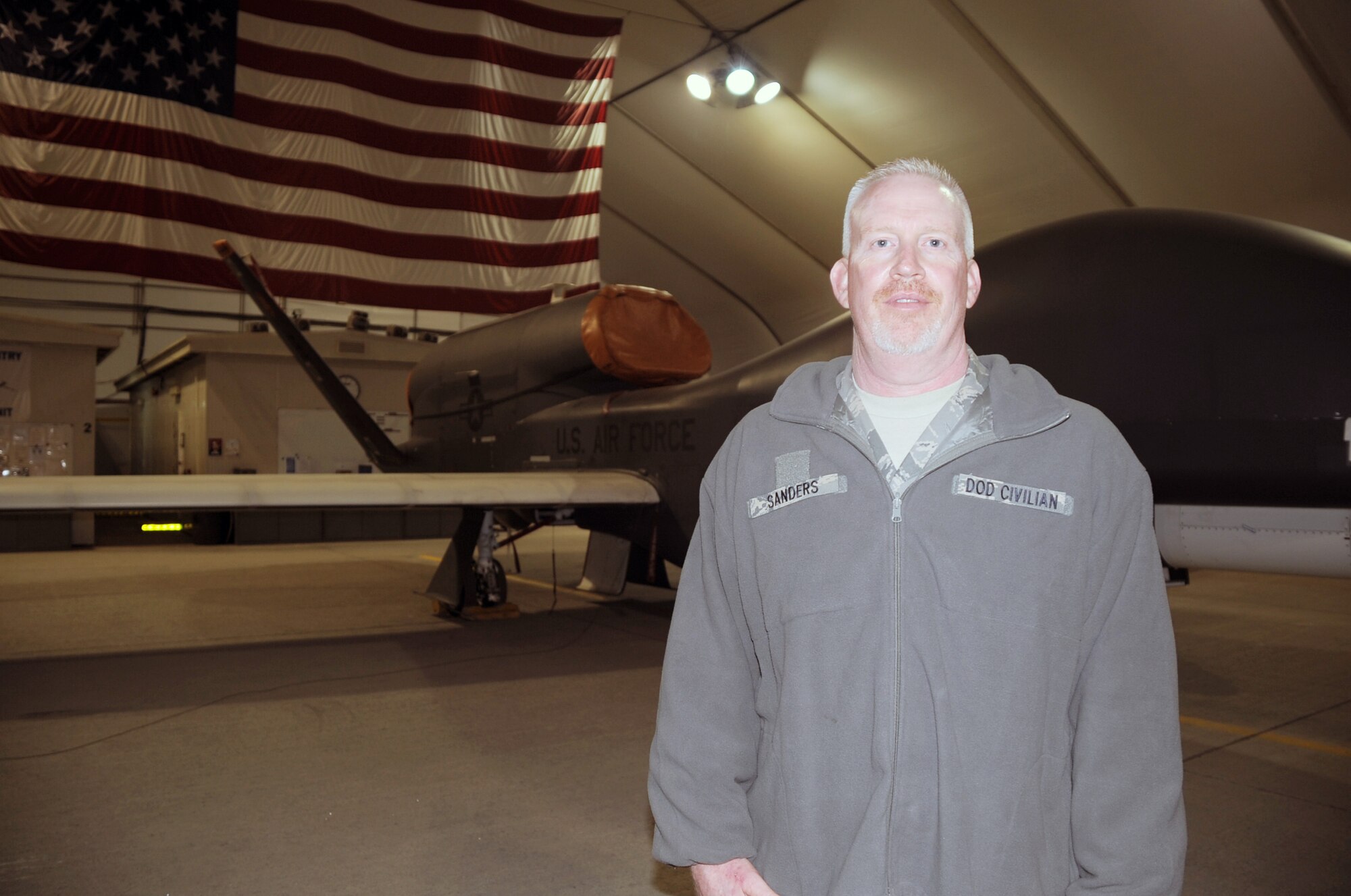 Mr. Mark Sanders is a GS-11 Department of Defense civilian employee and a retired chief master sergeant who works through the Air Force Engineering and Technical Services supporting the RQ-4 Global Hawk mission with the 380th Expeditionary Aircraft Maintenance Squadron Hawk aircraft maintenance unit at a non-disclosed base in Southwest Asia.  Here he is pictured by a Global Hawk on Feb. 12, 2010. He works in ground communications support for the Global Hawk and his hometown is Franklin, N.C. (U.S. Air Force Photo/Master Sgt. Scott T. Sturkol/Released) 