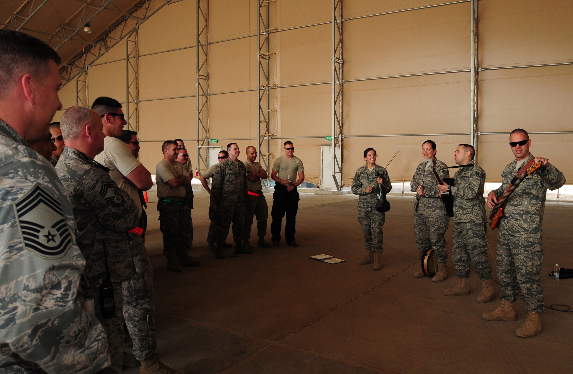 SOUTHWEST ASIA -- Members of the U.S. Air Forces Central Command Celtic Aire band entertain members of the 386th Expeditionary Aircraft Maintenance Squadron Feb. 13, 2010 at an air base in Southwest Asia. The undisclosed location is just one of many stops on the band's two-month tour through the AFCENT area of responsibility. (U.S. Air Force photo by Staff Sgt. Lakisha A. Croley/Released)