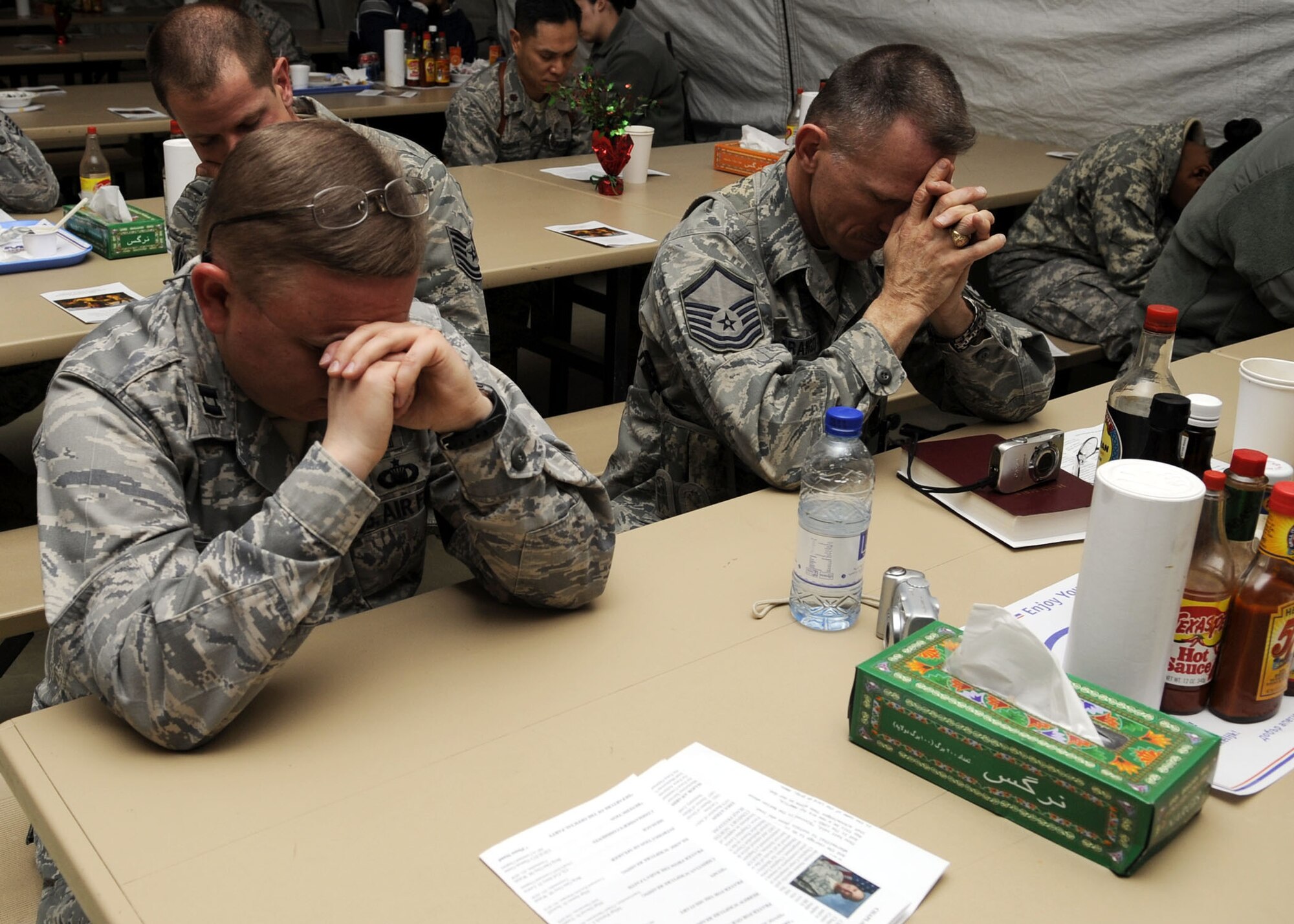 Chaplain (Capt.) Erik Harp and Master Sgt. Patrick Narango, 451st Air Expeditionary Wing, take a moment to reflect on prayer during the National Prayer Breakfast at the south park dining facility here Feb. 9, 2010.  The National Prayer Breakfast is held annually and is a traditional event used to reaffirm our nation’s spiritual heritage and to seek divine guidance.  (U.S. Air Force photo by Senior Airman Nancy Hooks/Released)