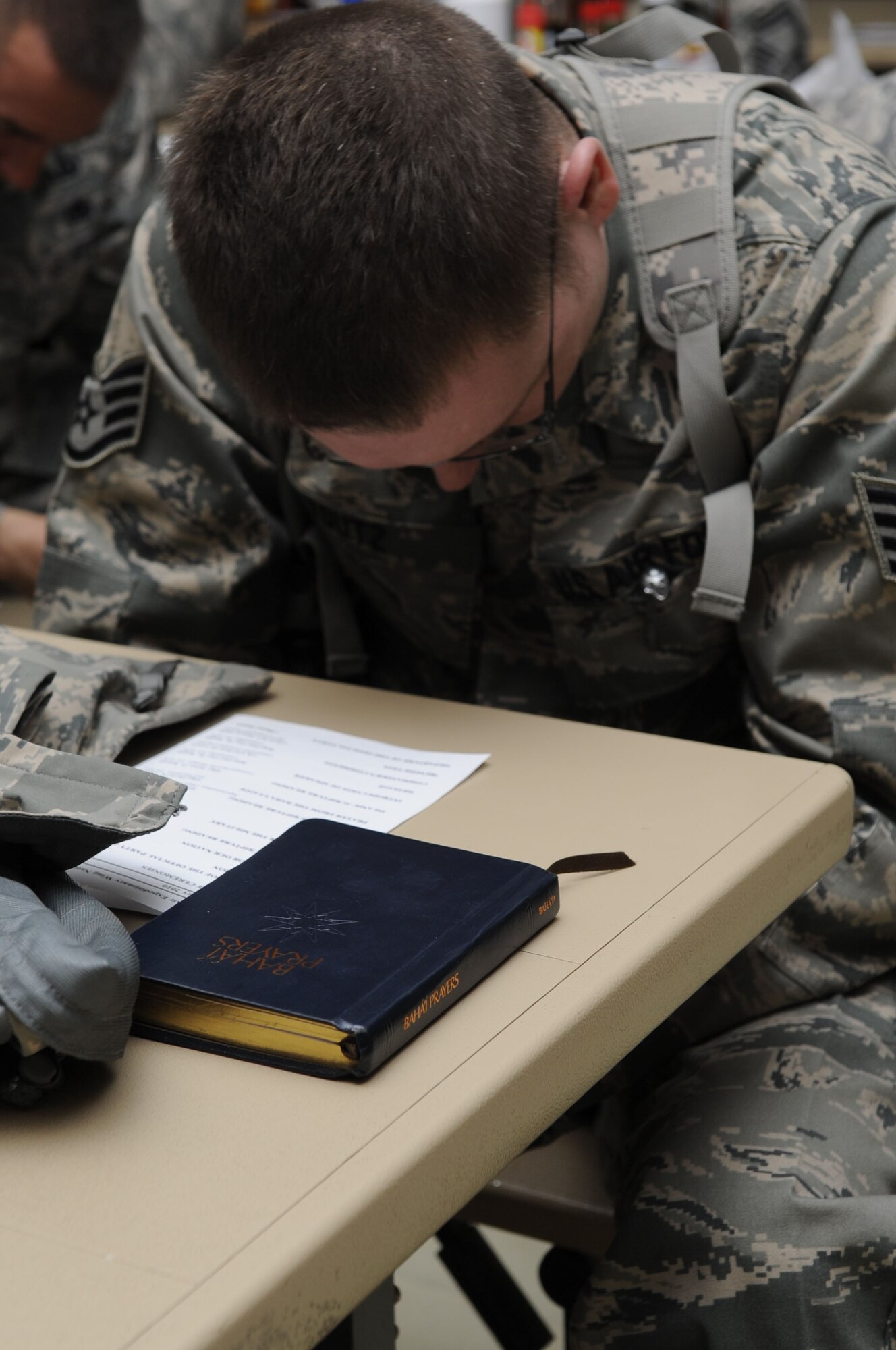 Staff Sgt David Youtz, 104th Expeditionary Fighter Squadron intelligence operations, reads a prayer from the Baha’I faith during the National Prayer Breakfast at the south park dining facility here Feb. 9, 2010.  The National Prayer Breakfast is held annually and is a traditional event used to reaffirm our nation’s spiritual heritage and to seek divine guidance.  (U.S. Air Force photo by Senior Airman Nancy Hooks/Released)