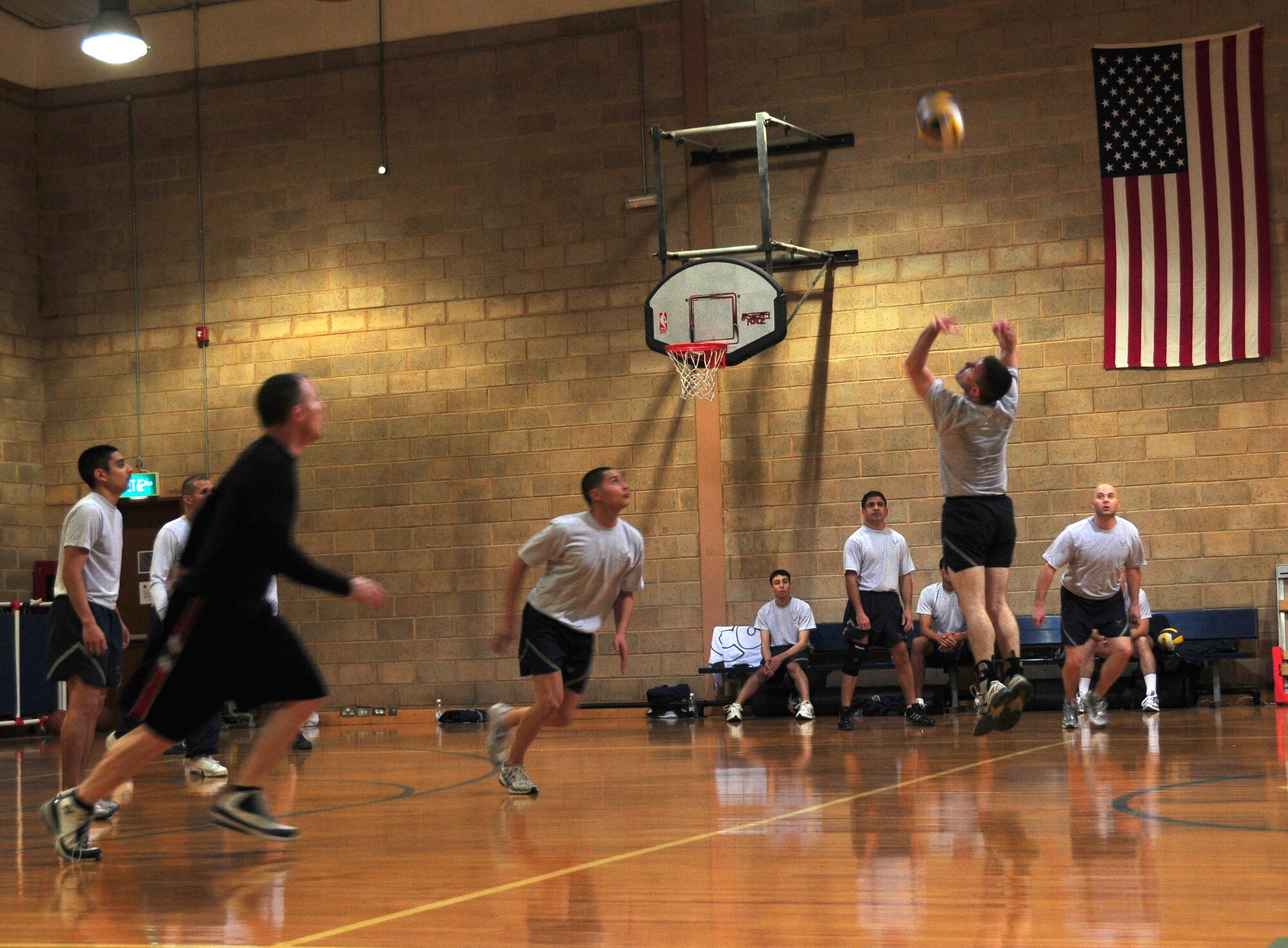 U.S. Air Force Tech. Sgt. Stephen Scott backsets Senior Airman Frederick Rosario, both of the 386th Expeditionary Communications Squadron, during the 386th Air Expeditionary Wing Intramural Volleyball championship game against the 386th AEW Wing Staff Feb. 11, 2010 at an air base in Southwest Asia. The Wing Staff defeated the 386th ECS in two out of three matches for the championship title. (U.S. Air Force photo by Staff Sgt. Lakisha Croley/Released)