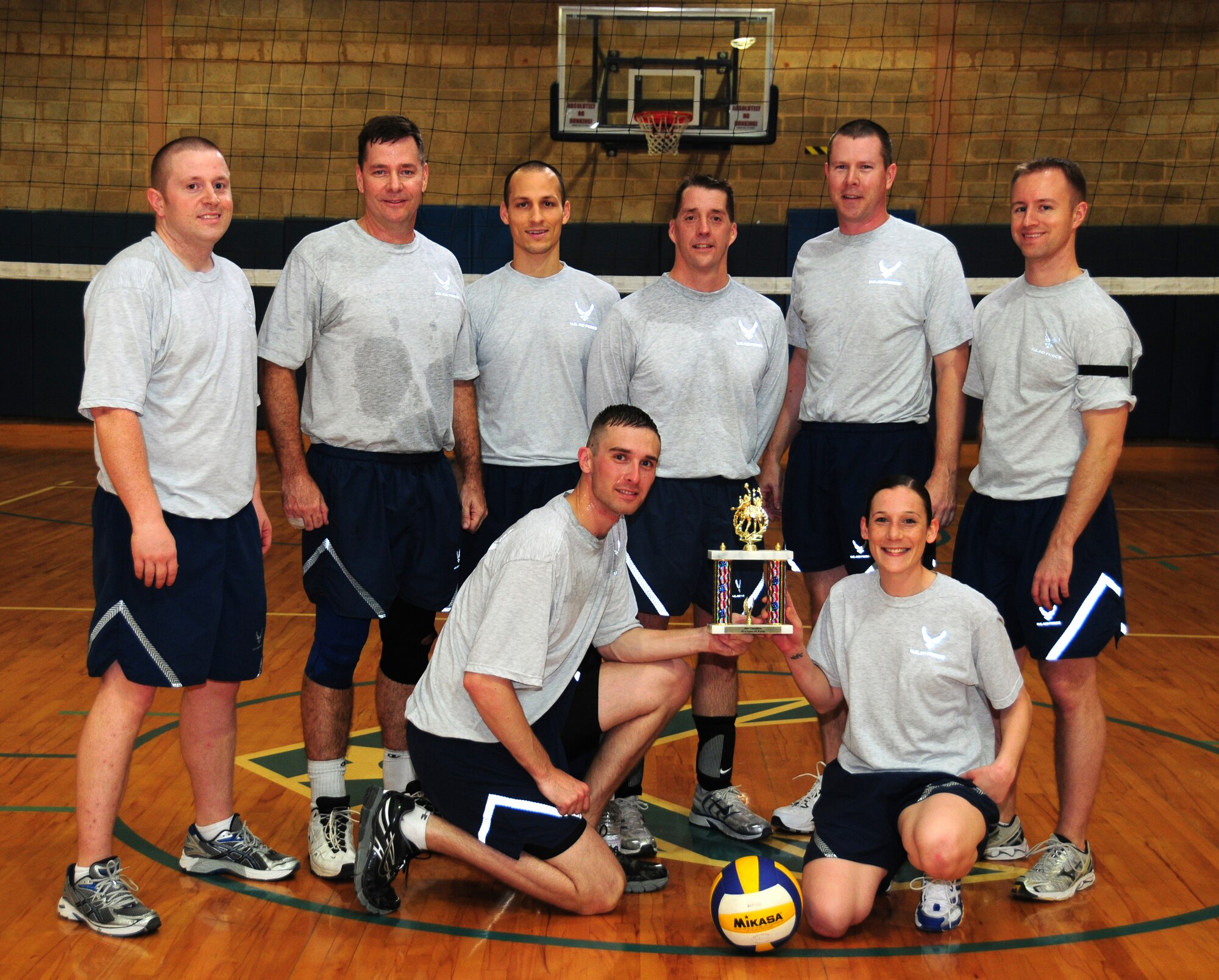 Clockwise from left: 386th Air Expeditionary Wing Staff volleyball team members 1st Lt. Grant Wisner, Col. Gary Gottschall, 2nd Lt. Jason Blair, Chief Master Sgt. Douglas McIntyre, Maj. Gregory Marty, Capt. Matthew Olson, Staff Sgt. Amy Cantrill and Tech. Sgt. David Maurice show off the 386th AEW Intramural Volleyball Championship trophy after defeating the 386th Expeditionary Communications Squadron in the best two out of three matches Feb. 11, 2010 at an air base in Southwest Asia. The 386th ECS won the first game 21-18, followed by two Wing Staff wins of 21-12 and 15-12. (U.S. Air Force photo by Staff Sgt. Lakisha A. Croley/Released)