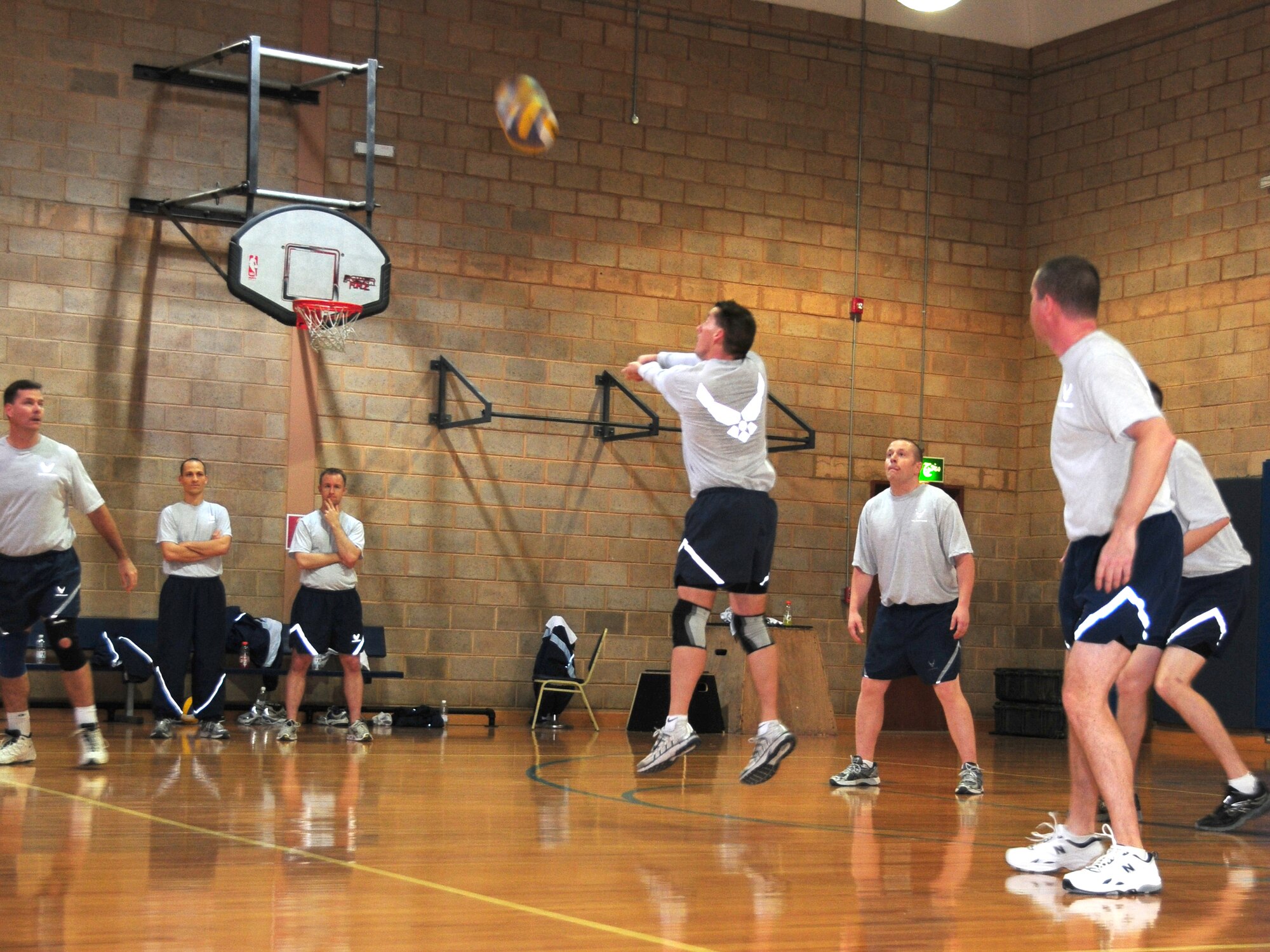U.S. Air Force Chief Master Sgt. Douglas McIntyre passes the ball to the 386th Air Expeditionary Wing Staff front line during the 386th AEW Intramural Volleyball Championship game against the 386th Expeditionary Communications Squadron Feb. 11, 2010 at an air base in Southwest Asia. The Wing Staff defeated the 386th ECS in two out of three matches for the championship title after closing out the regular season with a 10-1 record. The 386th ECS finished the regular season at 8-3. (U.S. Air Force photo by Staff Sgt. Lakisha A. Croley/Released)