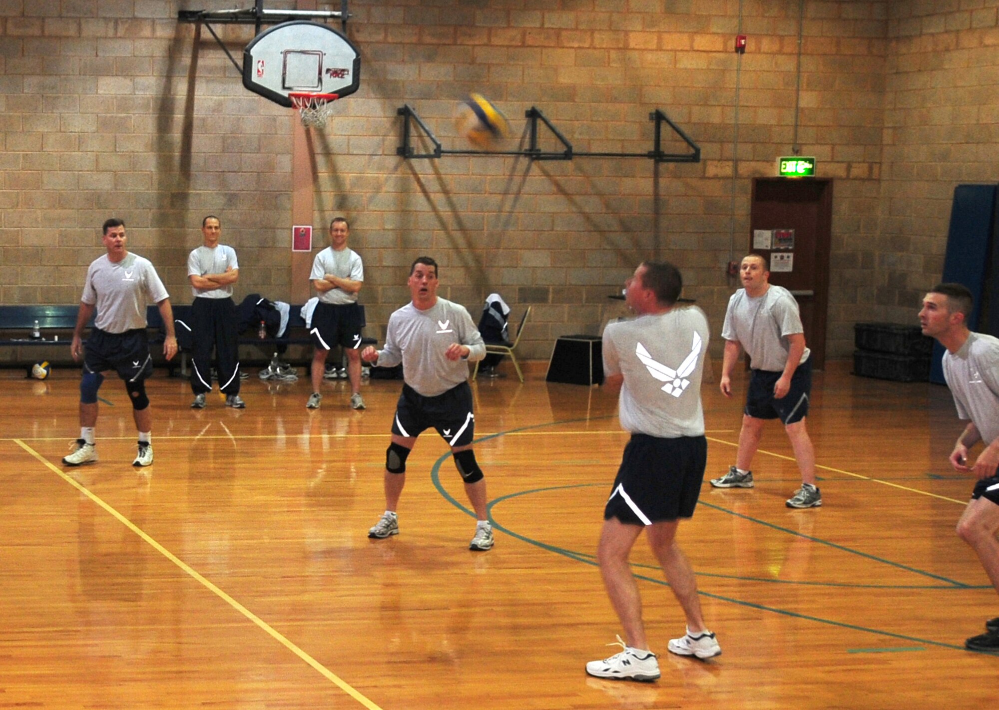 Maj. Gregory Marty, 386th Air Expeditionary Wing Staff, passes the ball to a teammate during the 386th AEW Intramural Volleyball Championship game against the 386th Expeditionary Communications Squadron Feb. 11, 2010 at an air base in Southwest Asia. The The Wing Staff defeated the 386th ECS in two out of three matches for the championship title. (U.S. Air Force photo by Staff Sgt. Lakisha Croley/Released)
