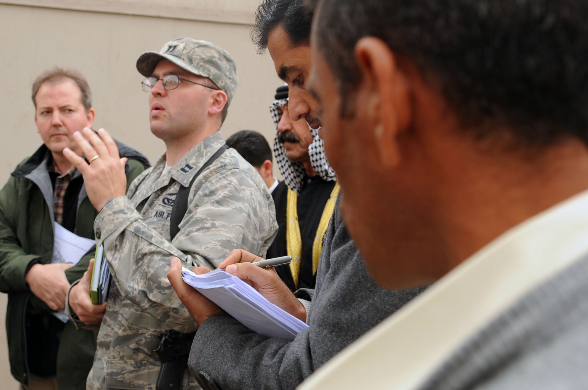 Capt. Jeffrey Hughes of the 332nd Expeditionary Civil Engineer Squadron discusses future construction projects with 14 Iraqi contractors who attended a tradeshow site visit at Joint Base Balad, Iraq, Feb. 6, 2010.  Bringing in the local contractors to complete the job will help build a stronger partnership. (U.S. Air Force photo/Senior Airman Brittany Y. Bateman/Released)

 
