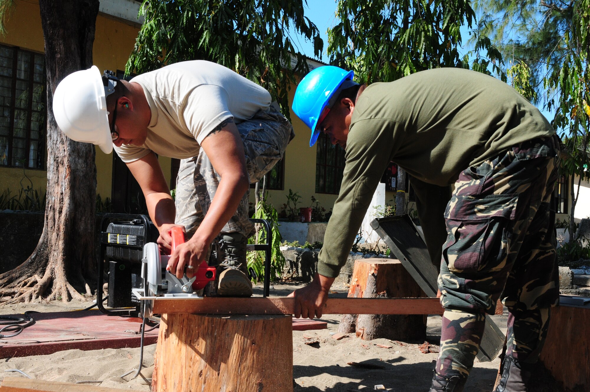 Tech. Sgt. Jimmy Tyquiengco, an engineer from the 254th Red Horse Squadron at Andersen Air Force Base, Guam, and Philippine Air Force Staff Sgt. Ramil Catubay, from the 356th Aviation Engineering Group, Armed Forces of the Philippines, work on a construction project during Operation Pacific Angel in Laoag, Philippines, Feb. 14. Operation Pacific Angel is a joint and combined humanitarian assistance operation conducted in the Asia-Pacific region to provide medical, dental and engineering assistance. The exercise is scheduled through Feb. 22 (U.S. Air Force Photo/Capt. Genieve David)