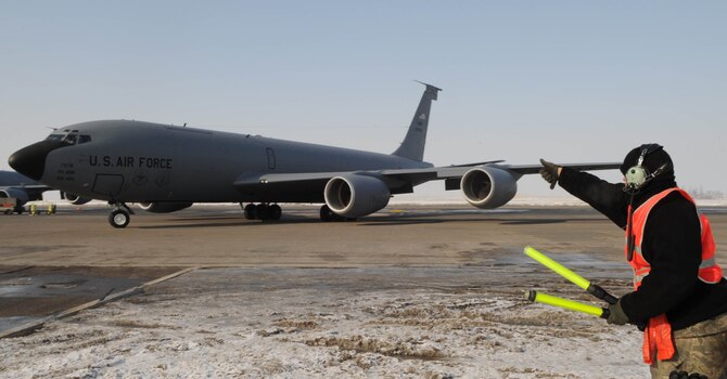 U.S. Air Force Staff Sgt. Liusel Rolon, 376th Expeditionary Aircraft Maintenance Squadron jet engine mechanic, marshals a KC-135 Stratotanker to the taxiway before take-off from the Transit Center at Manas, Kyrgyzstan, Feb. 16, 2010. In a typical flight, a KC-135 refuels several aircraft, and in the course of a deployment they'll off-load millions of pounds of fuel to hundreds of aircraft, supporting thousands of troops on the ground. (U.S. Air Force photo/Senior Airman Nichelle Anderson/released)