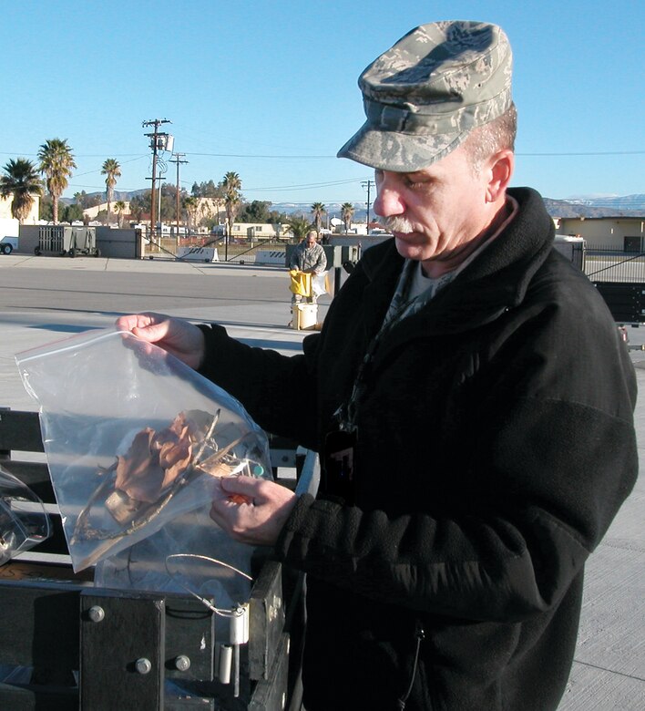 As walkers return their bags, Master Sgt. Todd Mollerup searches each for unusual FOD. (U.S. Air Force photo by Megan Just)