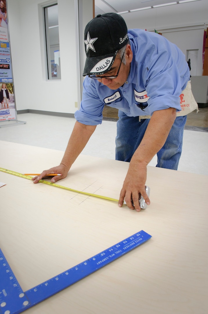 Randolph AFB, TX, 2/16/2010:  Robert Barba with the Army Air Force Exchange Service?s Facility Management Office measures slat wall in preparation for cutting an electrical outlet opening in preparation for Randolph Air Force Base, Base Exchange?s March 2010 grand opening.(U.S. Air Force photo/Steve Thurow)