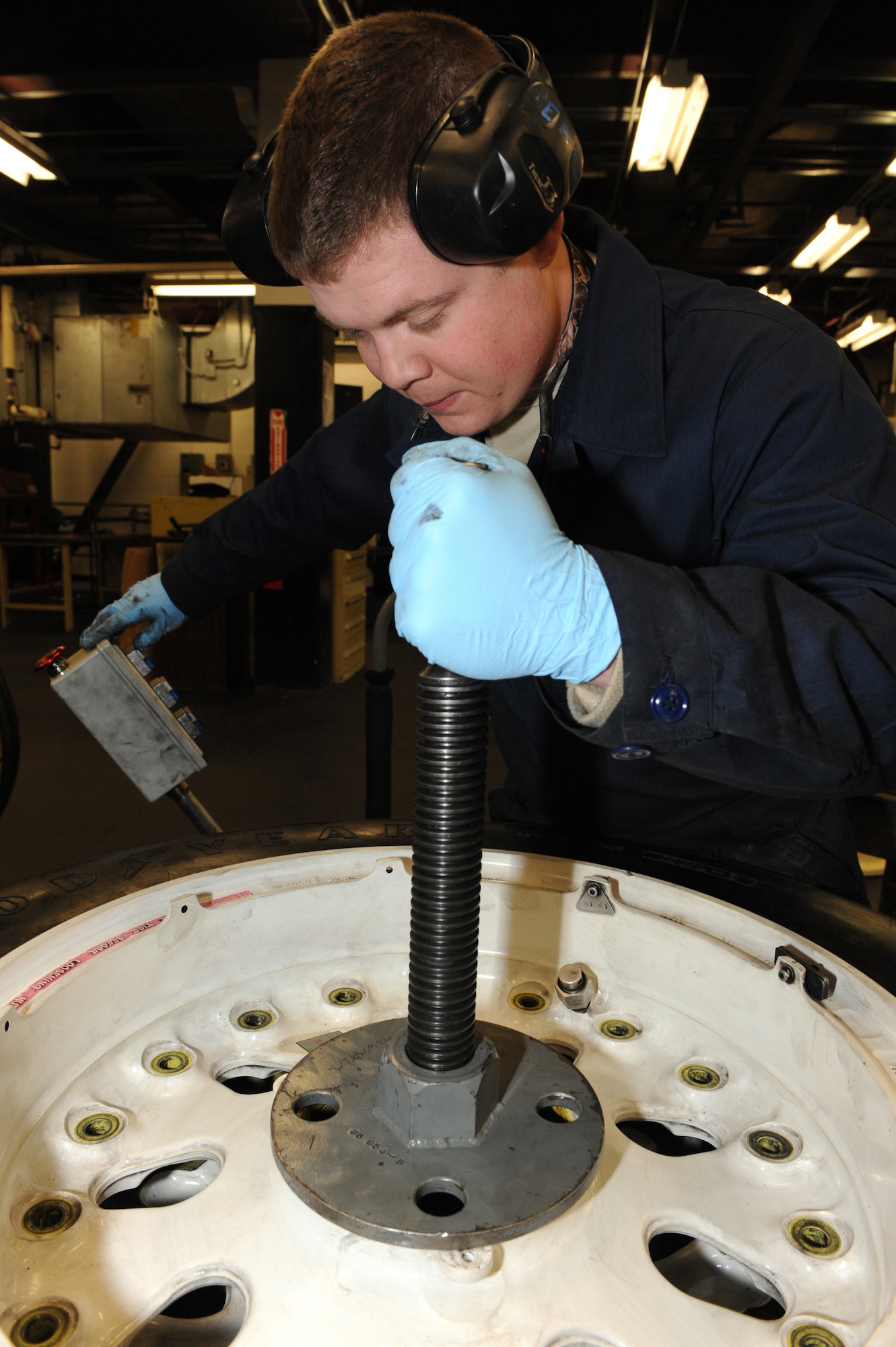 WHITEMAN AIR FORCE BASE, Mo. - Senior Airman Eric Pearl, 509th Aircraft Maintenance Squadron wheel and tire shop technician, presses two wheel halves together with the “wheel machine,” Feb. 16, 2010. Each B-2 wheel weighs in excess of 275 lbs., and requires the use of specialized, automated equipment for assembly.  (U.S. Air Force photo/Airman 1st Class Carlin Leslie)
