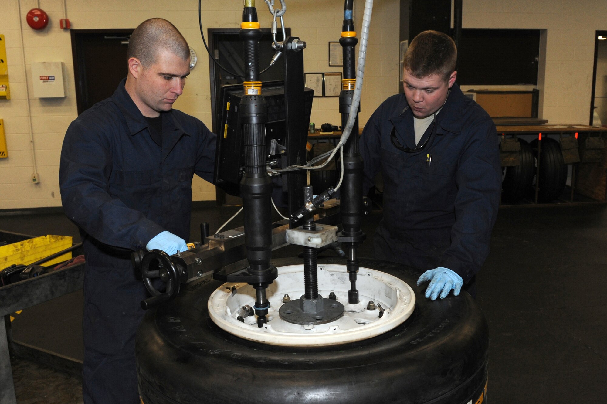 WHITEMAN AIR FORCE BASE, Mo. - Staff Sgt. Travis Hughes and Senior Airman Eric Pearl, 509th Aircraft Maintenance Squadron wheel and tire shop technicians, Put the finishing touches on a B-2 wheel assembly before rolling it to the inflation machine, Feb. 16, 2010.  Aircraft tires are filled with Nitrogen, an inert gas that expands and contracts very little in varying temperatures and altitudes.  (U.S. Air Force photo/Airman 1st Class Carlin Leslie)