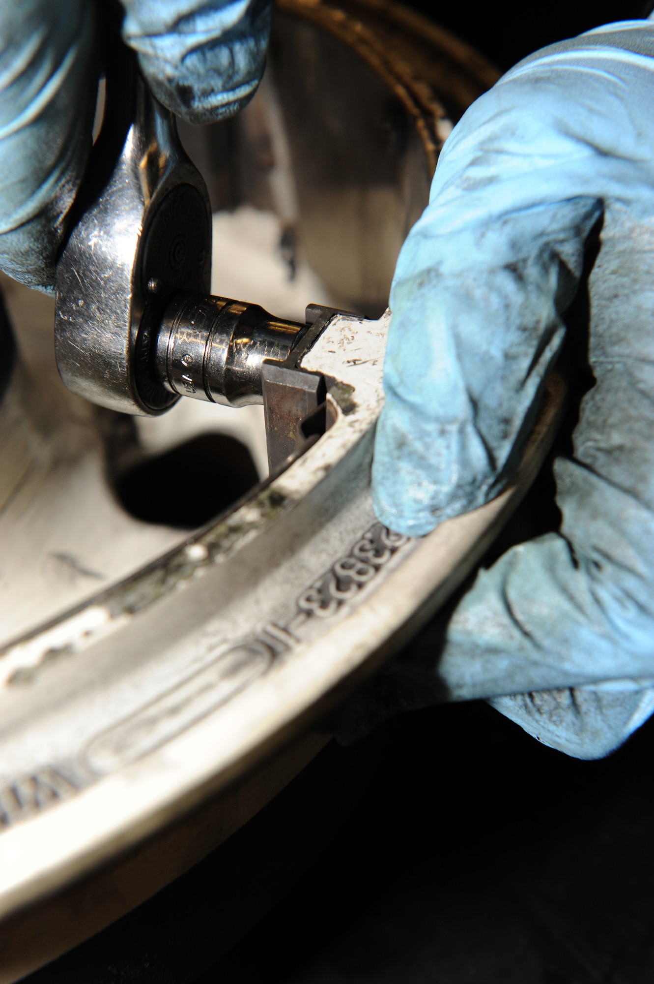 WHITEMAN AIR FORCE BASE, Mo. - An Airman from the 509th Aircraft Mantainence Squadron wheel and tire shop disassembles a T-38 wheel for inspection Feb. 16, 2010.  T-38 tires last anywhere from a week to 3 weeks, depending on the number of missions flown.   (U.S. Air Force photo/Airman 1st Class Carlin Leslie)