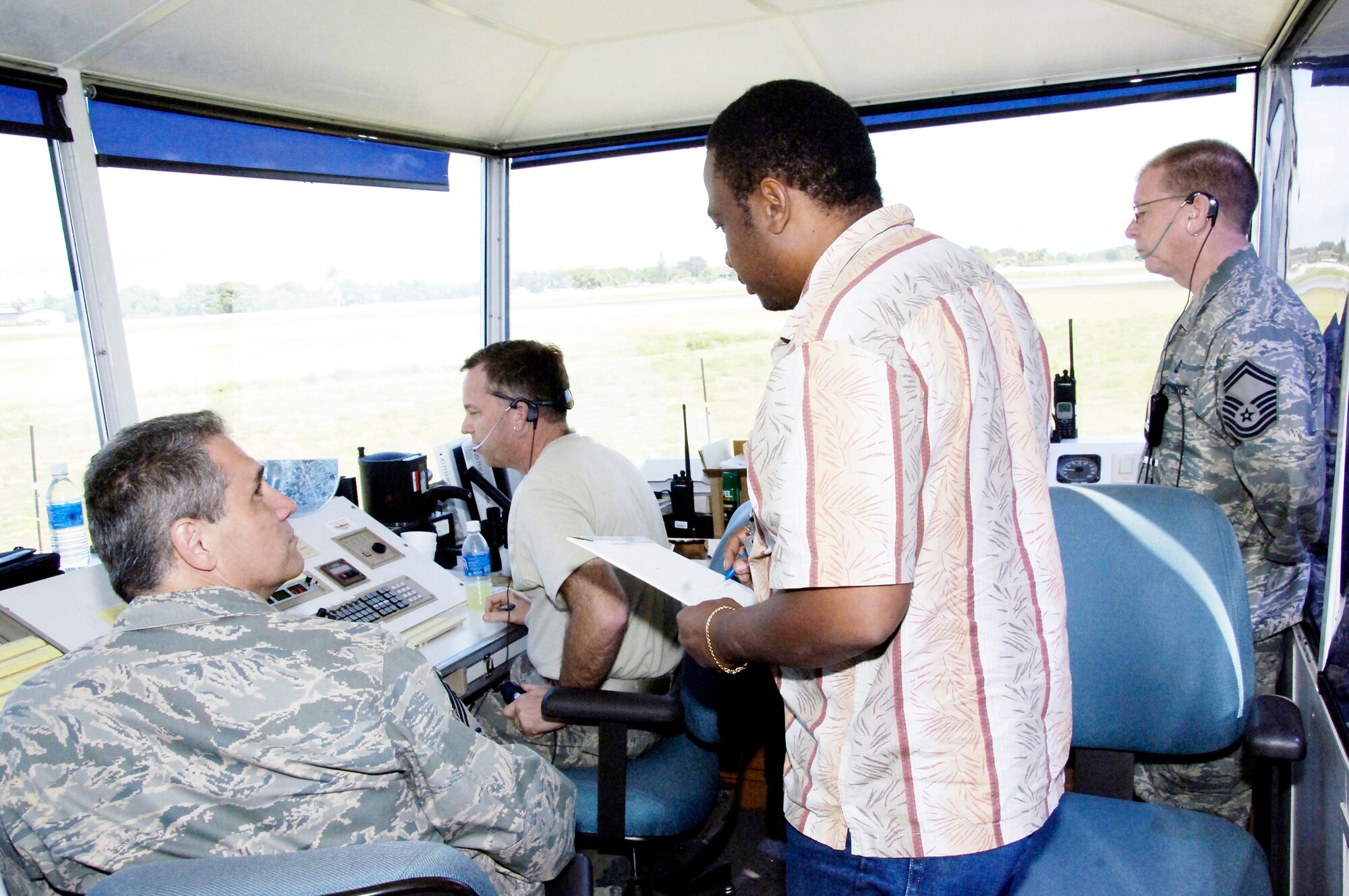 Reginald Bailey receives familiarization instruction from Air Force air traffic controllers in the mobile tower Feb. 1, 2010, at the airport in Port-au-Prince, Haiti. The transition is currently taking place to hand over the tower and all flight operations responsibilities over to the Haitians. Mr. Bailey is a Haitian air traffic controller. (U.S. Air Force photo/Tech. Sgt. Larry W. Carpenter Jr.)