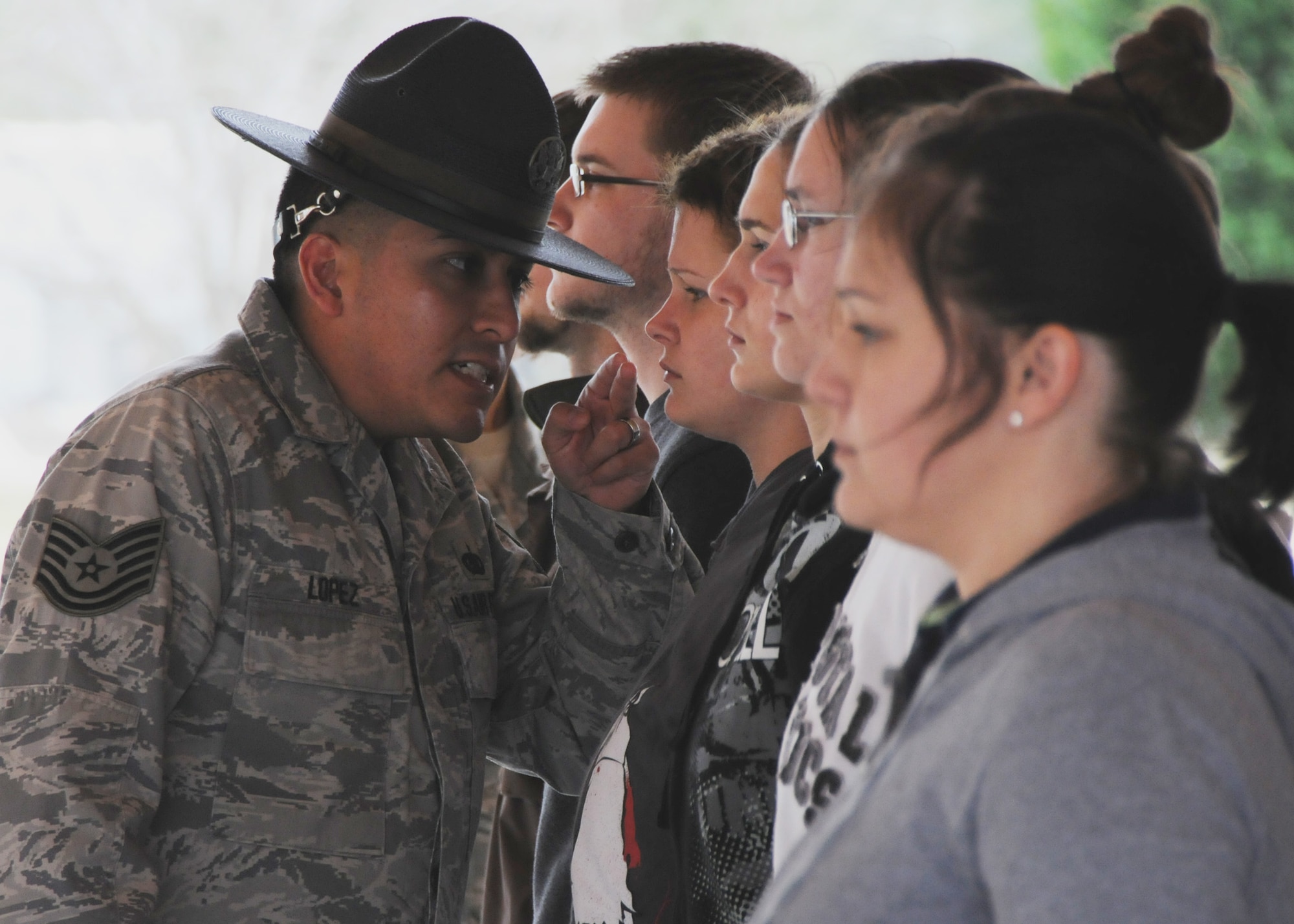 Tech. Sgt. Raul Lopez corrects a new Air Force Reserve recruit Feb. 6, 2010, at Duke Field. Sergeant Lopez and his wife, Master. Sgt. Tiffany Lopez (pictured) both former active-duty military training instructors at  Lackland Air Force Base, Texas, volunteered their time to help new reserve recruits prepare for basic training during the drill weekend here. The husband and wife team spent four years instructing new trainees at Lackland graduating 25 flights from Basic Military Training. Sergeant Tiffany Lopez is assigned to the 96th Force Support Squadron. Sergeant Raul Lopez is assigned to the 96th Logistics Readiness Squadron. (U.S. Air Force photo/Tech. Sgt. Samuel King Jr.)