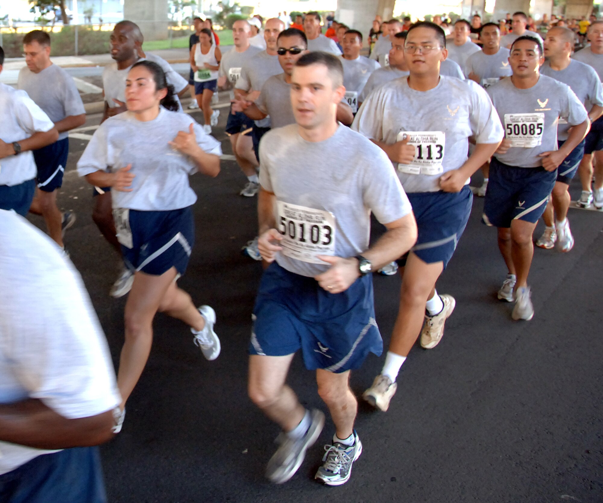 Airmen run in formation at the Great Aloha Run Feb. 15. The run began at Aloha Tower, finished at Aloha Stadium, and boasted more than 17,000 participants. (U.S. Air Force photo by Senior Airman Nathan Allen)